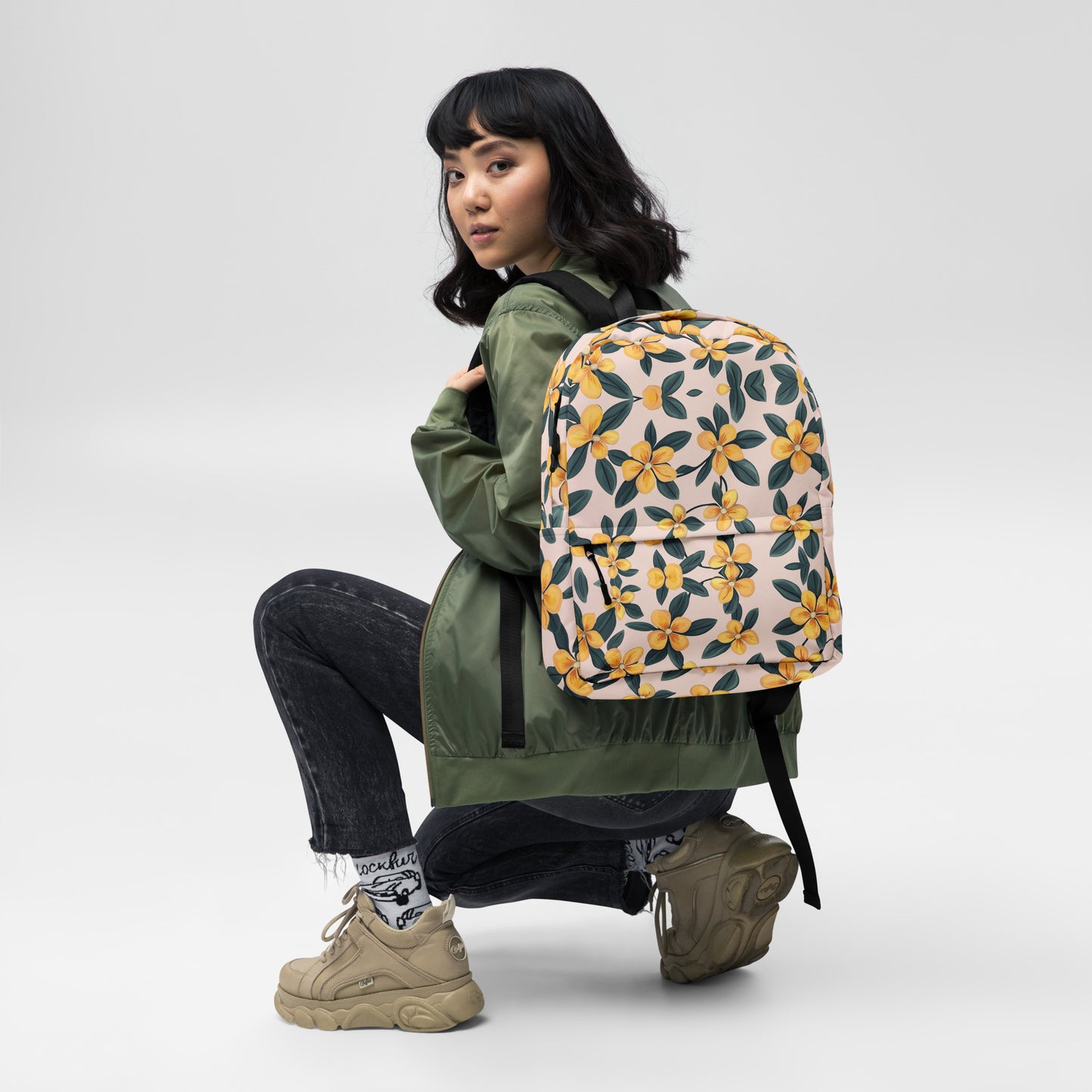 Woman wearing the Flower Patterns Are a Girl's Best Friend backpack, showcasing its medium size and comfortable fit.