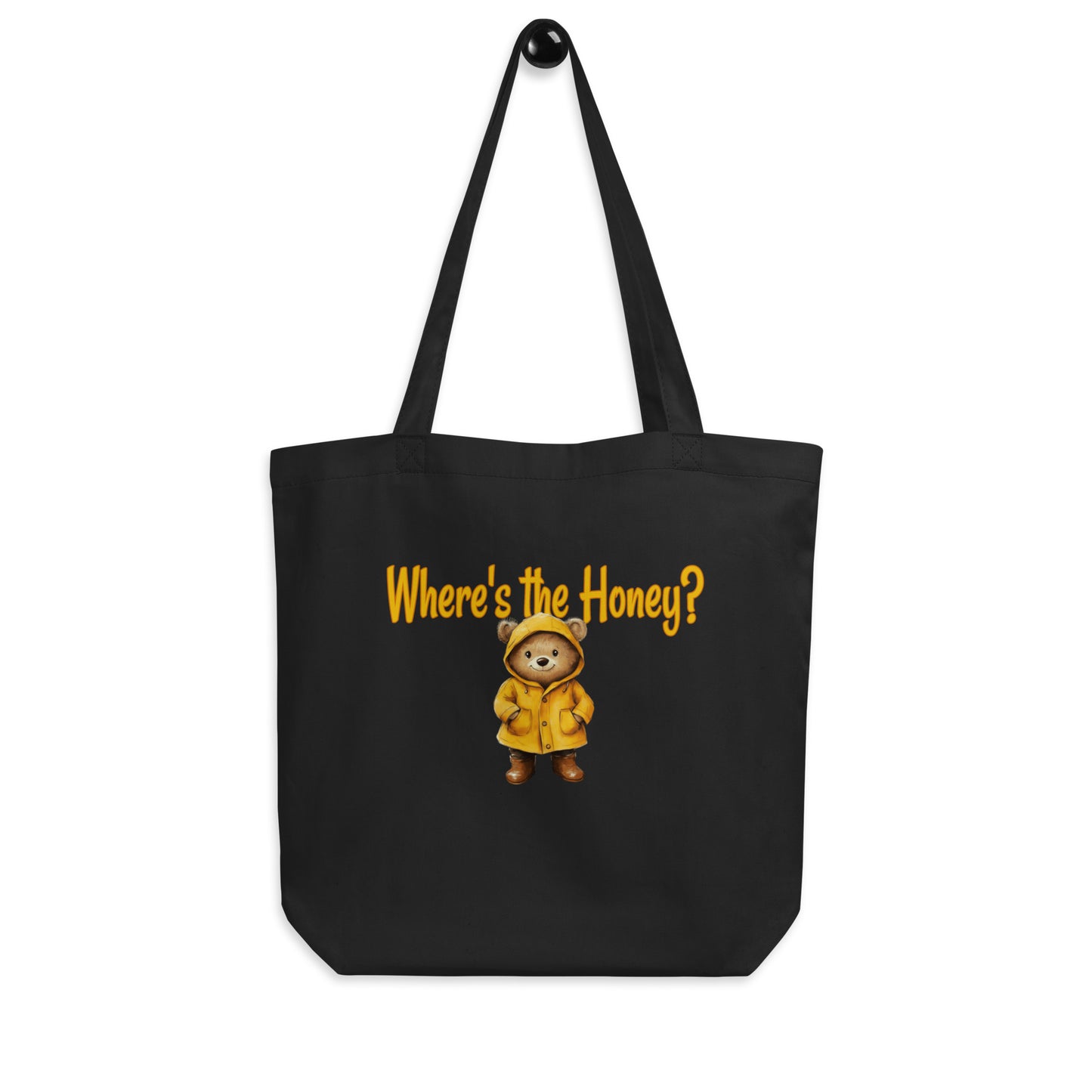 Black tote bag with a bear in a yellow raincoat and text 'Where's the Honey?' on a white background.
