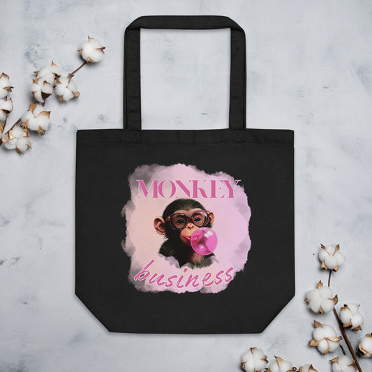 Sustainable black cotton tote bag featuring the 'Monkey Business' chimpanzee artwork, durable and spacious for eco-conscious daily use.