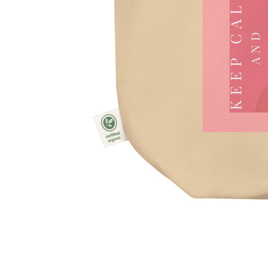 Close up of a sustainable oyster tote bag with pink giraffe illustration and text 'Keep Calm and Recycle' on a white background.