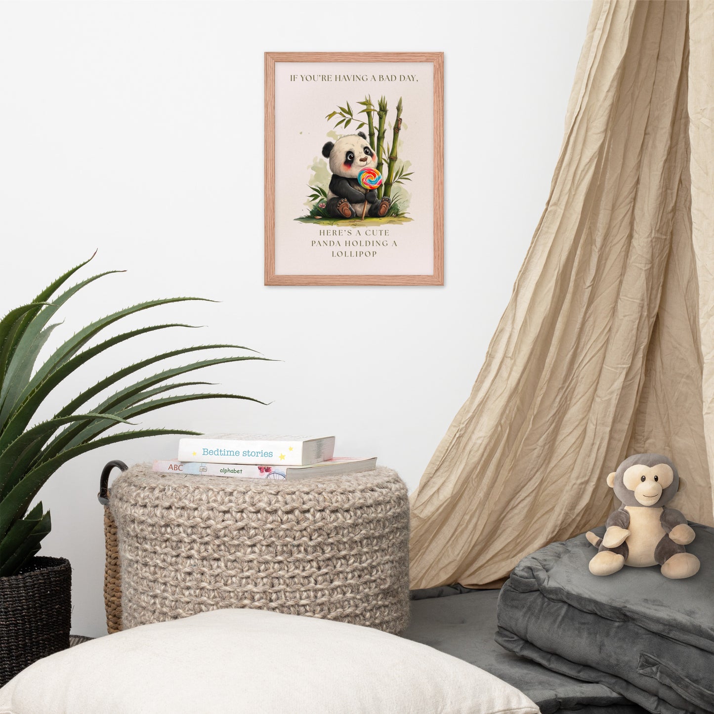 Nursery room with a framed poster of a panda holding a colorful lollipop. There is wicker ottoman, and a plush monkey toy in the room.