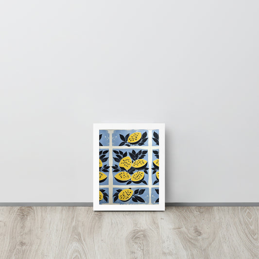 Framed artwork with yellow watermelon design in a white frame on a light gray wall.