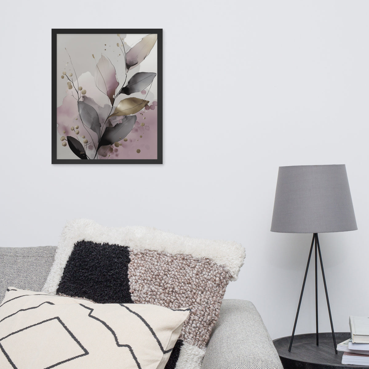 Framed floral art on a wall above a sofa with decorative pillows and a lamp.