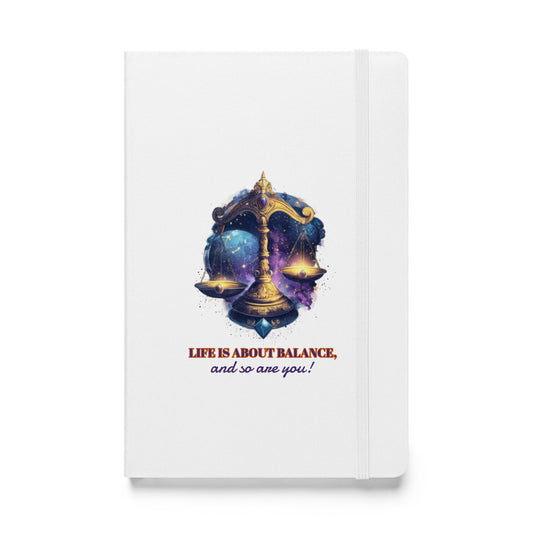 White hardcover notebook featuring a colorful, artistic Libra zodiac scale design by Sweet & Savage.
