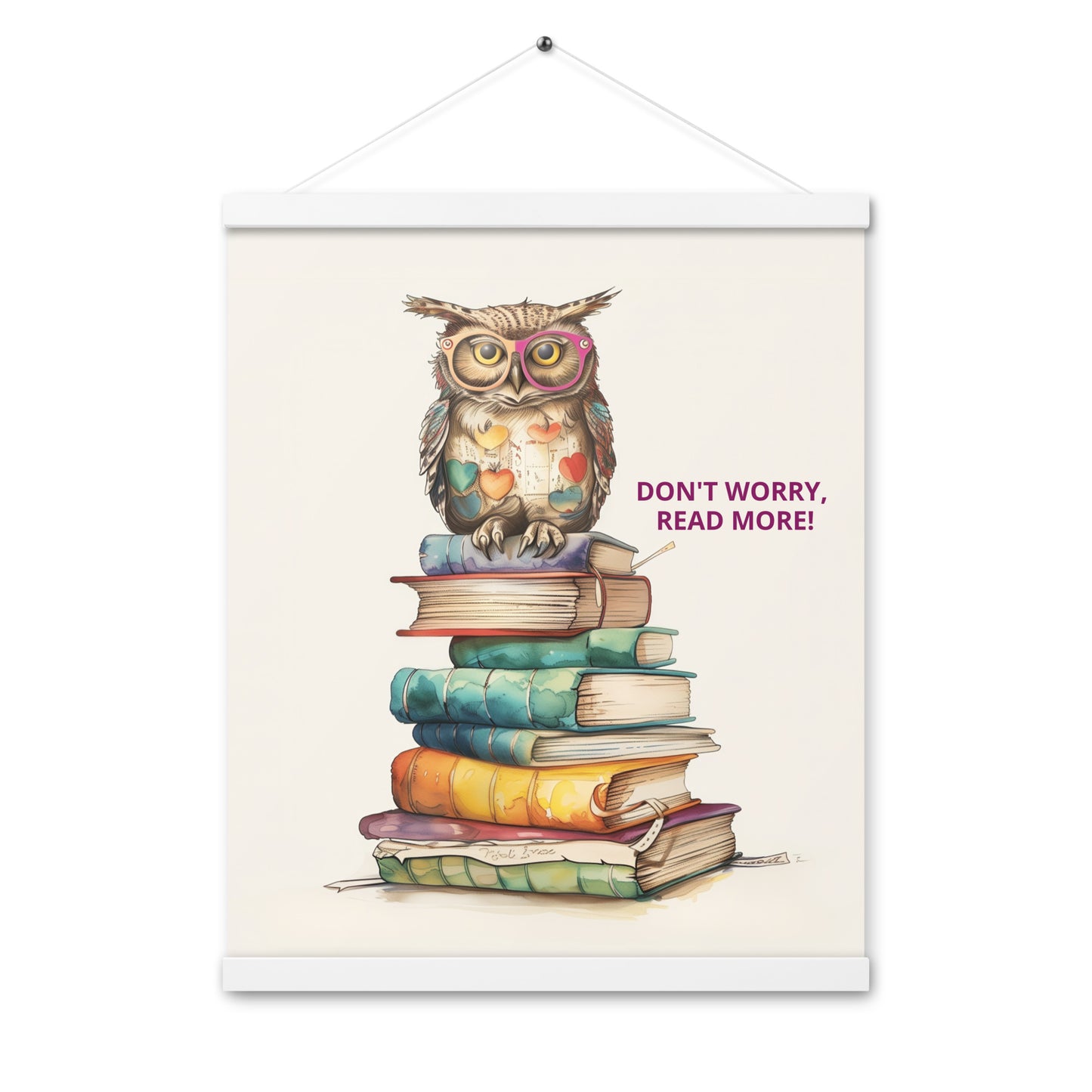 Whimsical illustration of an owl sitting on a tall stack of colorful books with the text "Don't Worry, Read More!". The poster is displayed with natural light-wood magnetic hangers and a hanging string.