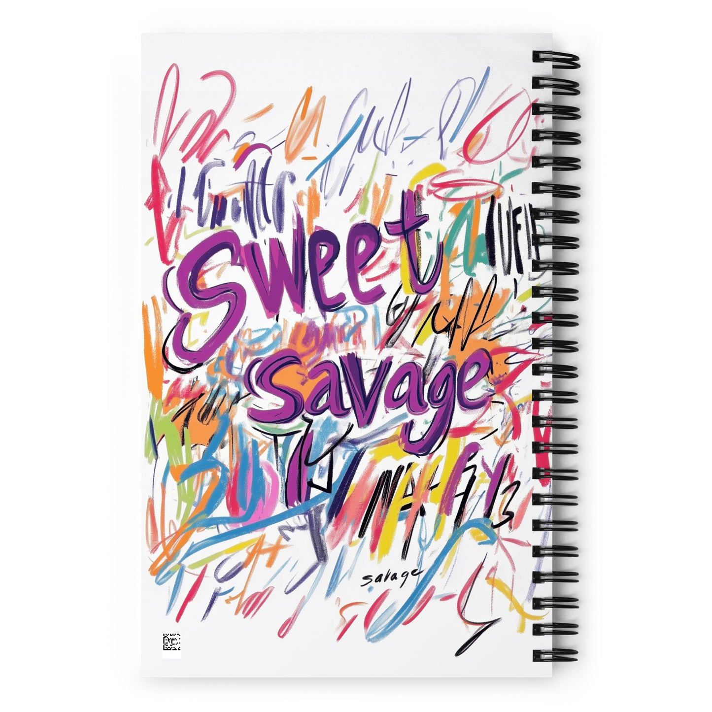 Spiral notebook with a white background featuring vibrant purple and multi-colored "Sweet Savage" artistic typography and expressive scribbles.