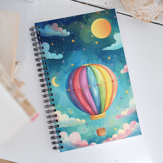 Spiral notebook featuring an enchanting air balloon and galaxy art design on a soft background by Sweet & Savage.