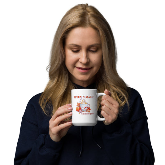 Woman holding a mug with text 'Autumn Magic with. a dash of boo!' on a white background