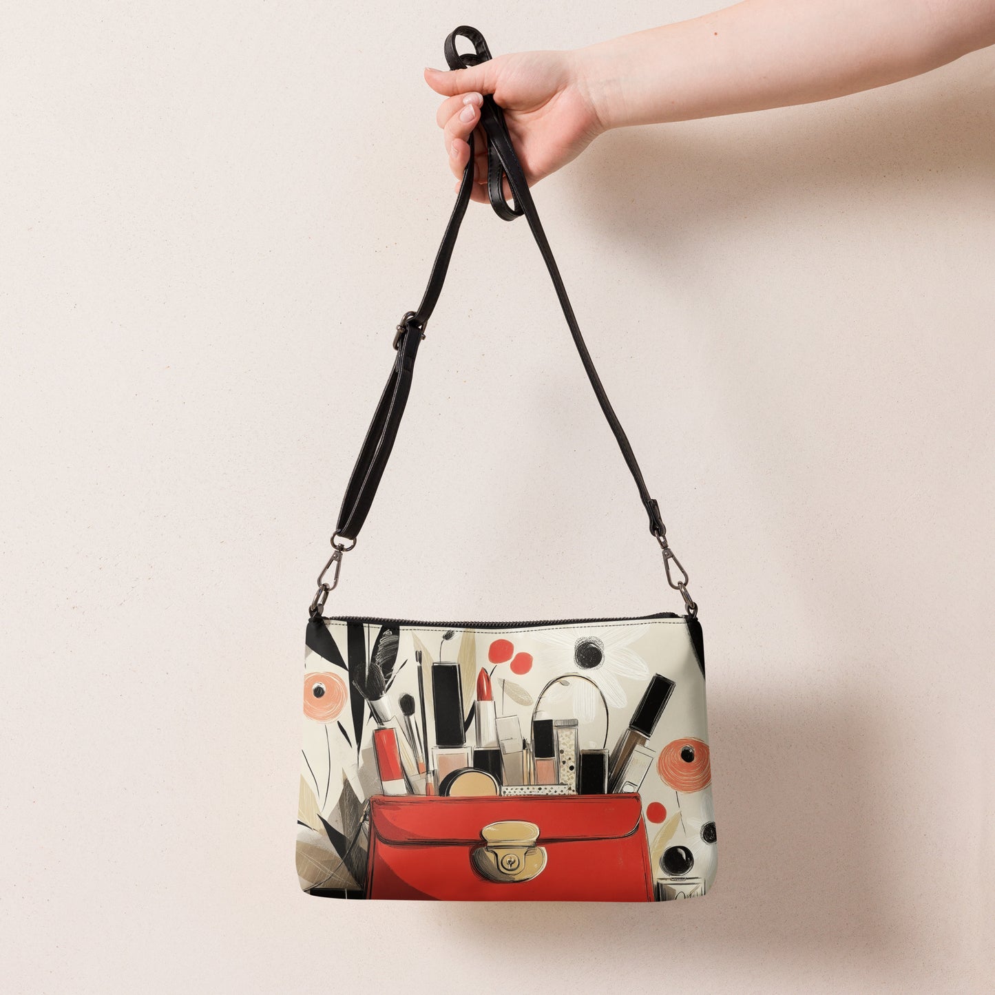 A hand holding a crossbody bag with a print design that features luxurious makeup items by Sweet and Savage. 