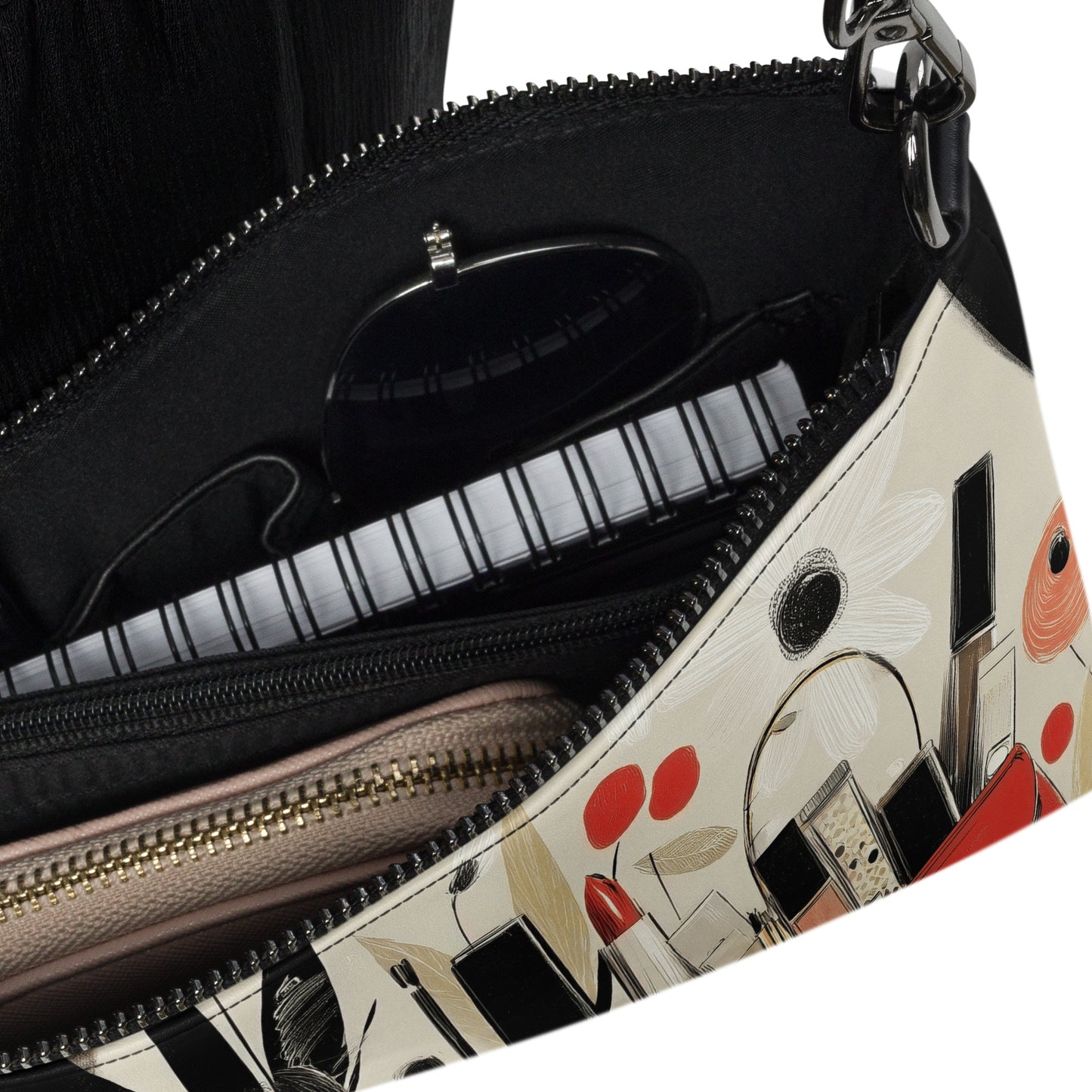 A closeup of a crossbody bag with a print design that features luxurious makeup items by Sweet and Savage. 