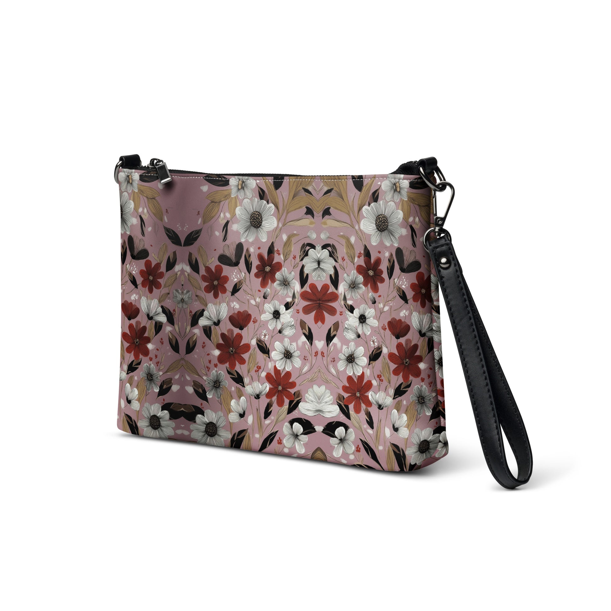 Floral patterned crossbody bag with black strap on a white background. 