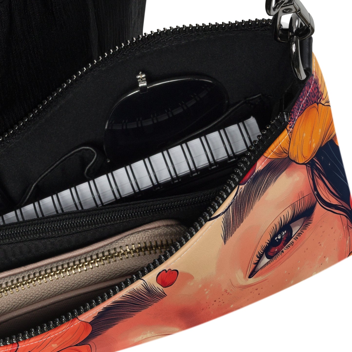 Close up of a crossbody bag with a colorful design of a woman's face on a white background. 