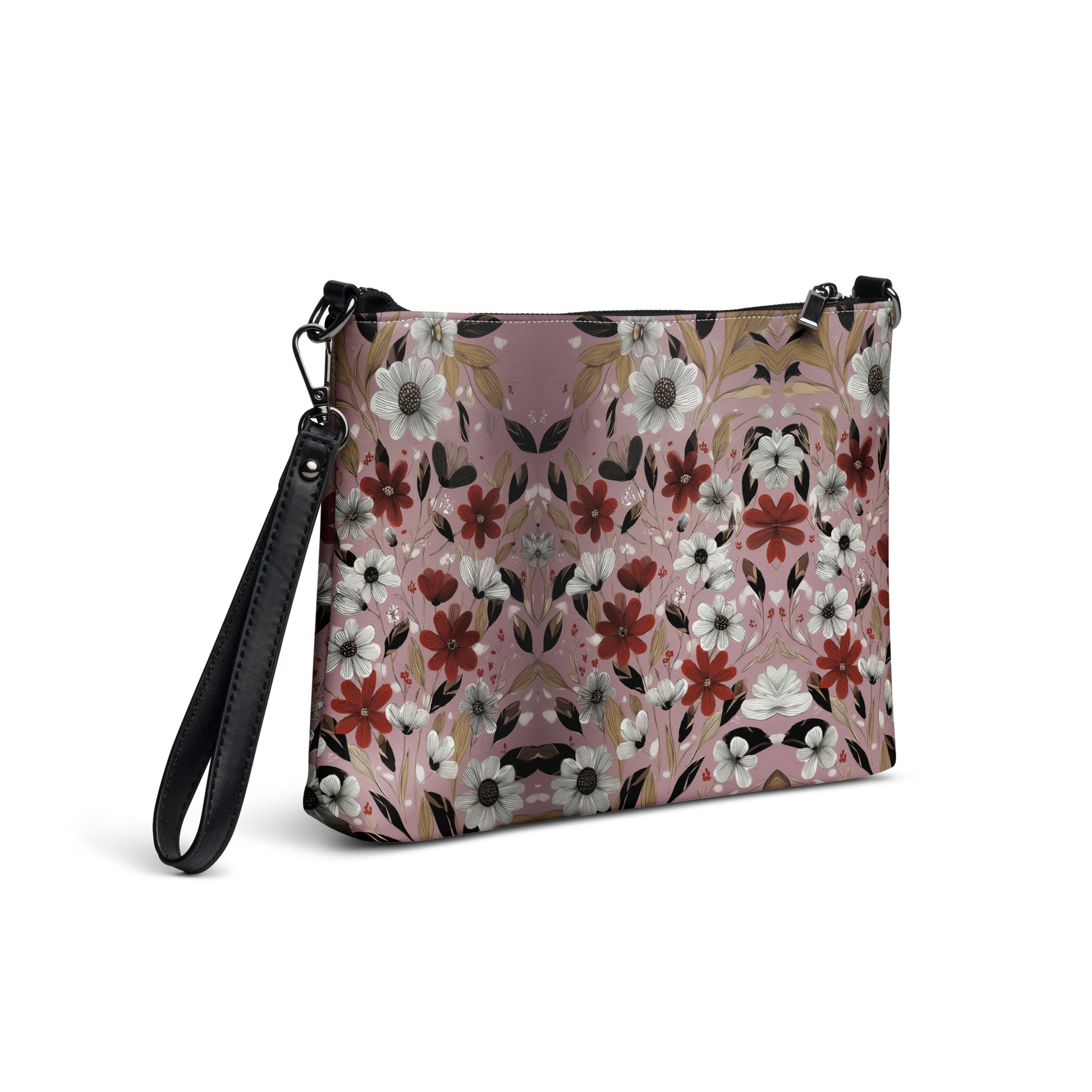 Floral patterned crossbody bag with black strap on a white background. 