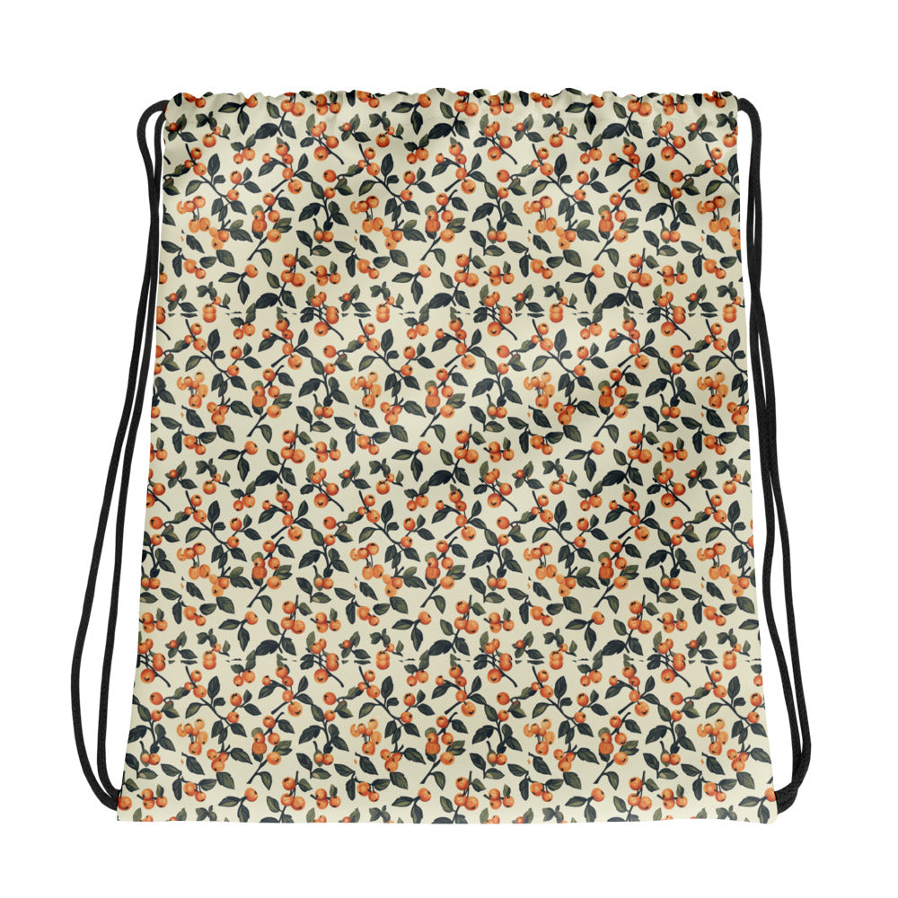 Drawstring bag with a floral pattern featuring red cherries on a beige background.