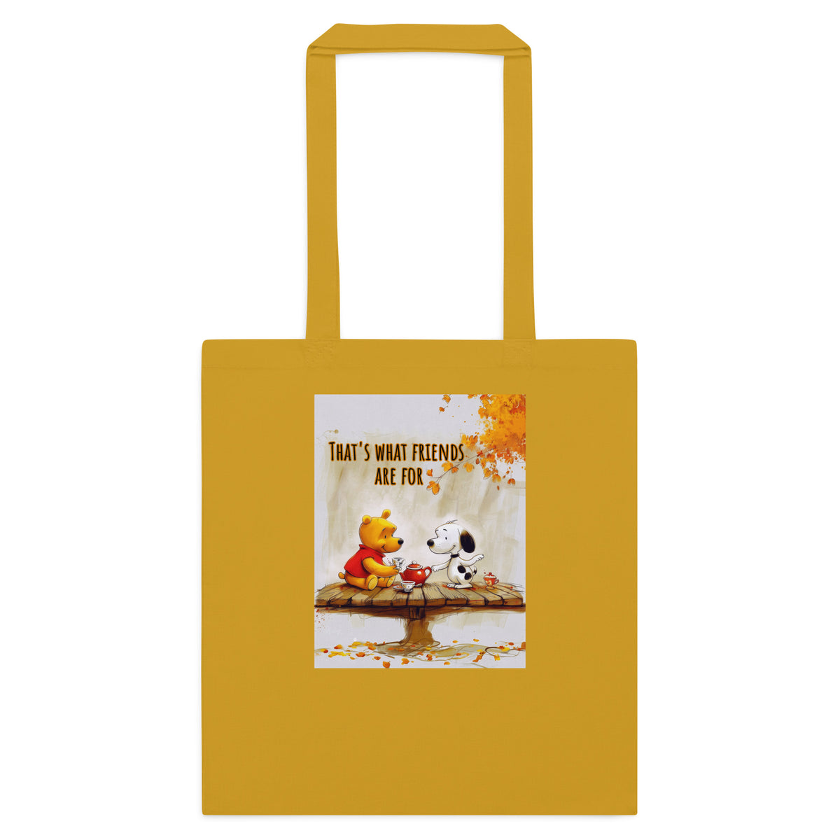 A mustard yellow canvas tote bag with two shoulder straps, featuring a printed graphic of Winnie the Pooh and Snoopy sitting on a bench with autumn leaves and the text 'THAT'S WHAT FRIENDS ARE FOR'.
