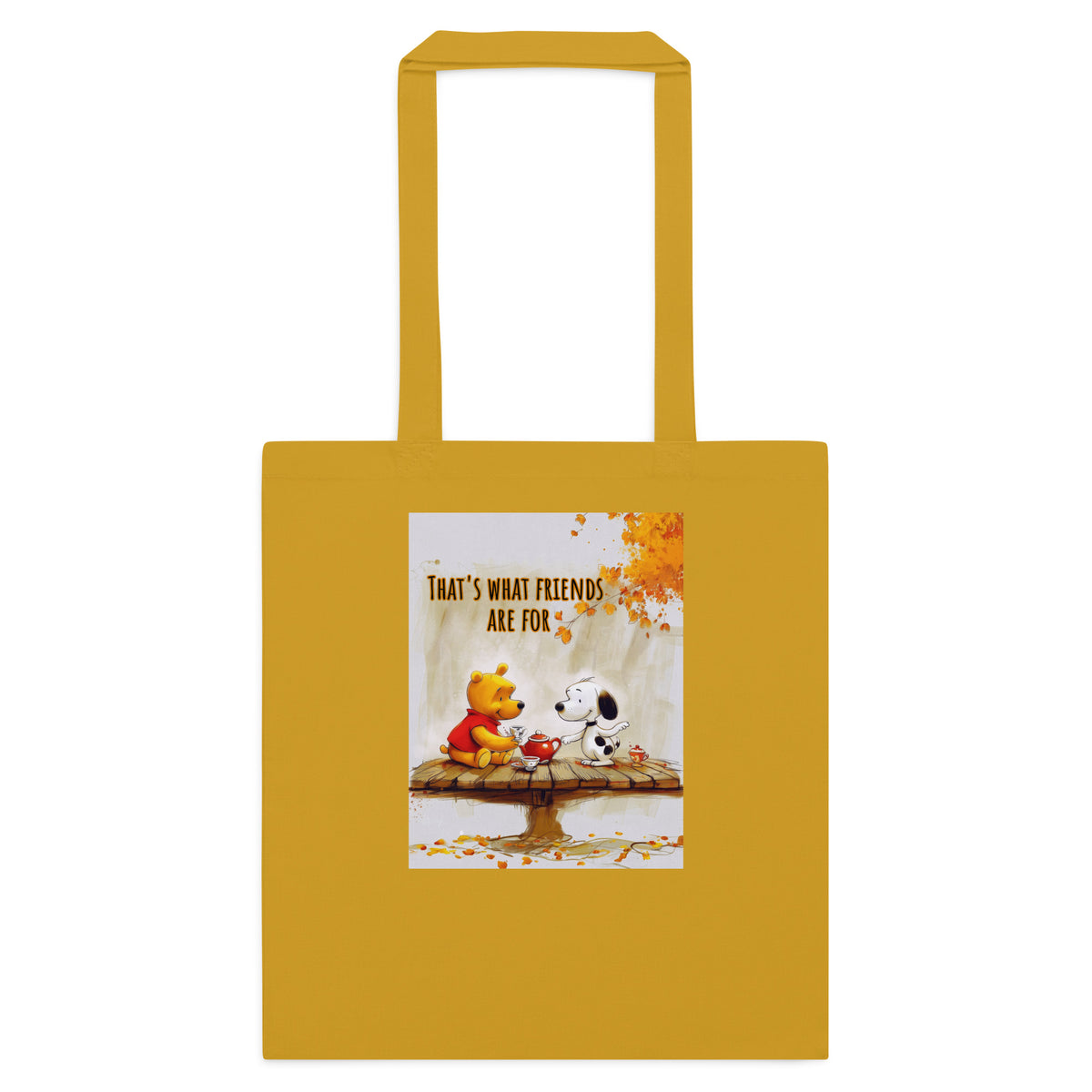A mustard yellow canvas tote bag with two shoulder straps, featuring a printed graphic of Winnie the Pooh and Snoopy sitting on a bench with autumn leaves and the text 'THAT'S WHAT FRIENDS ARE FOR'.