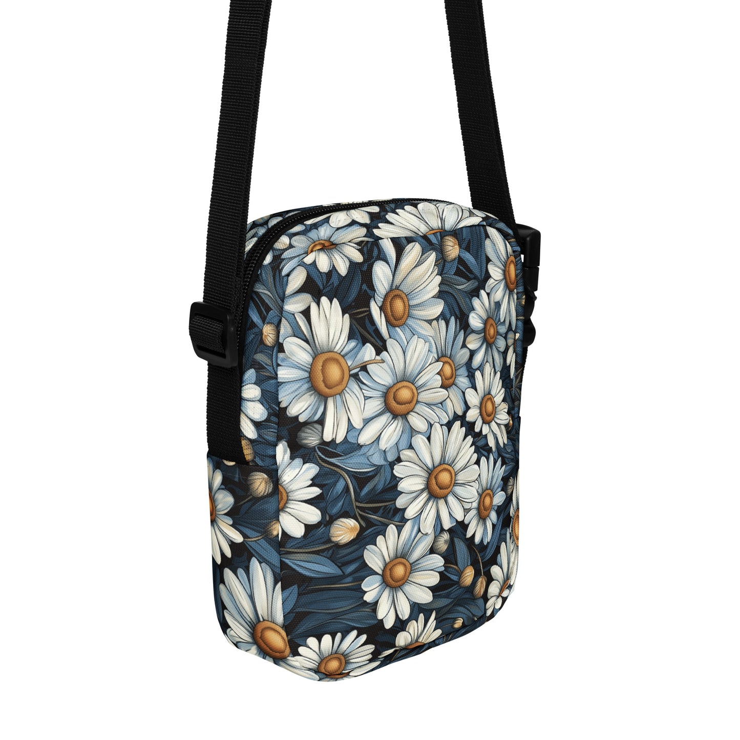 Crossbody bag daisy floral pattern with a black strap on a white background. 