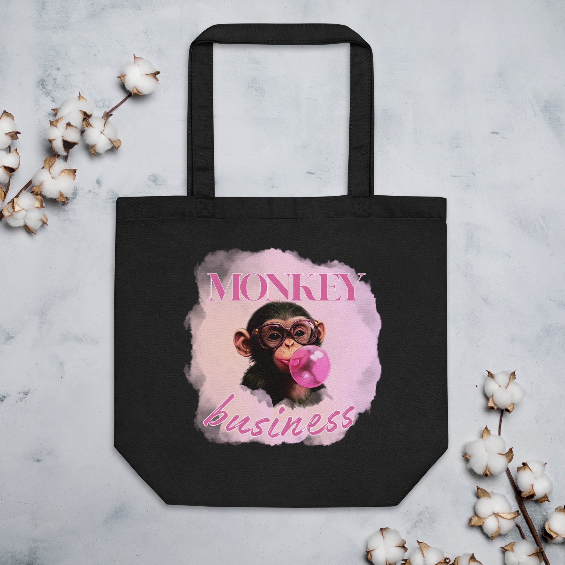 Sustainable black cotton tote bag featuring the 'Monkey Business' chimpanzee artwork, durable and spacious for eco-conscious daily use.
