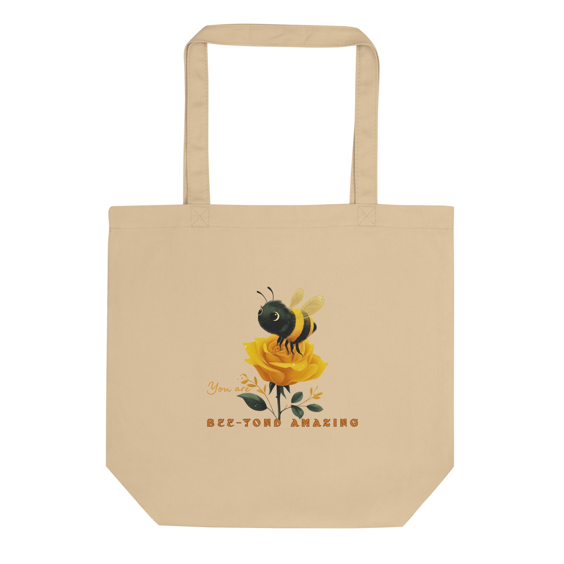 Beige eco tote bag with a bee and rose yellow rose design with the words 'You are Bee-yond amazing' on a white background. 