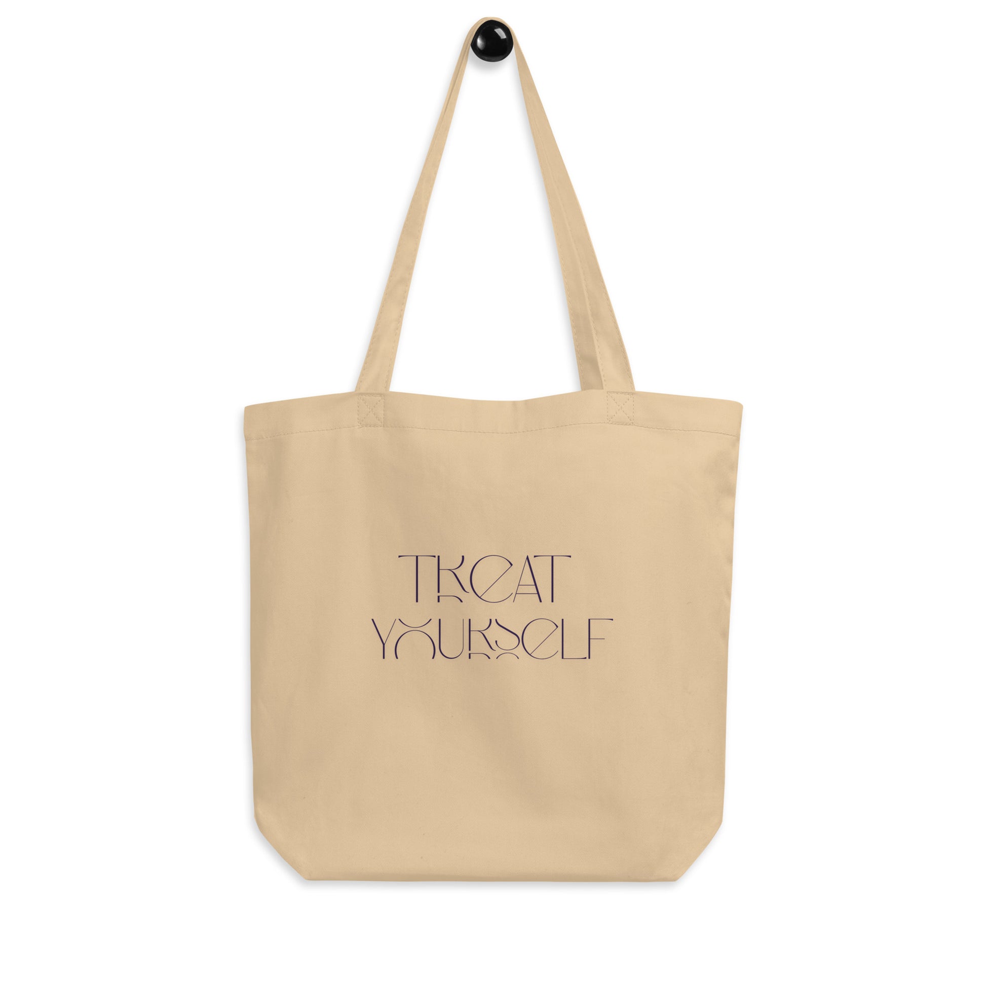Beige tote bag with black text on a white background.