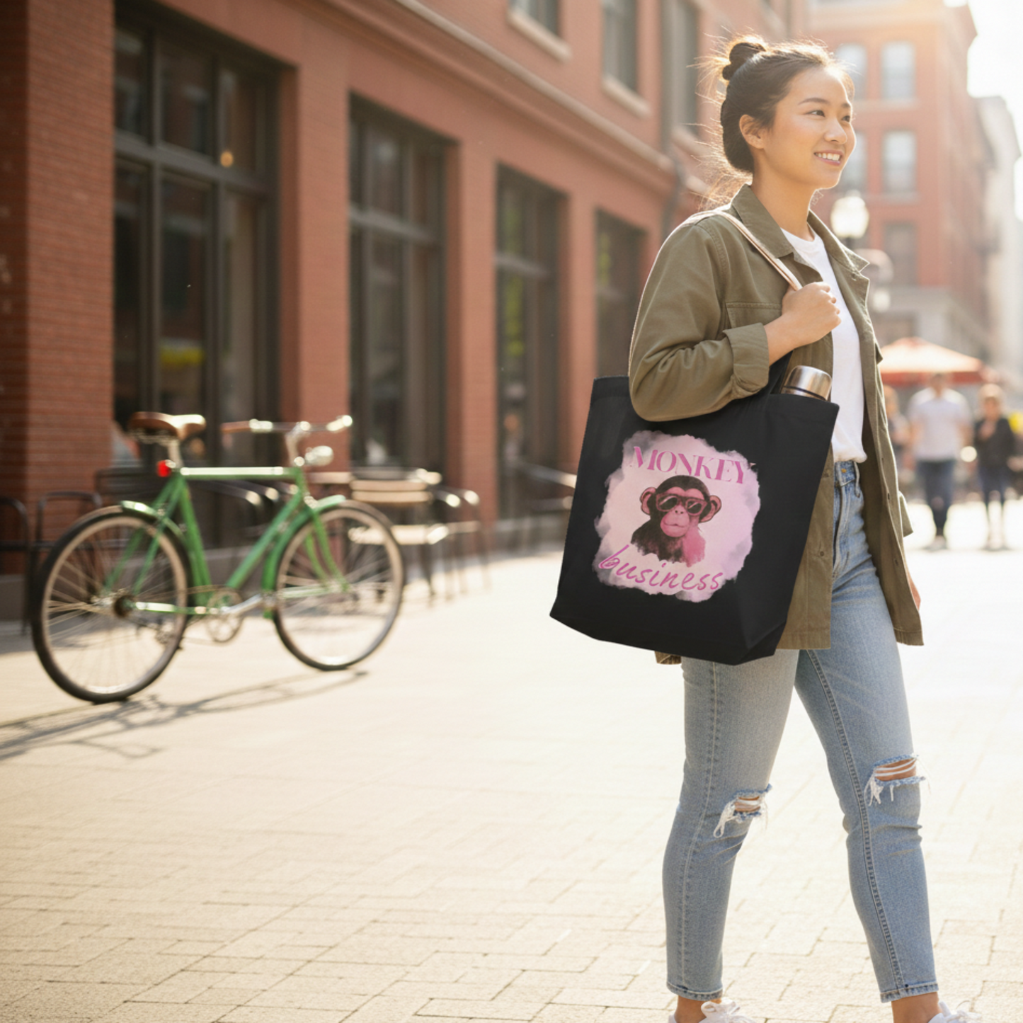 Lifestyle shot of a black eco-friendly tote bag with a graphic chimp and bubblegum design, styled in a city setting for the conscious shopper.