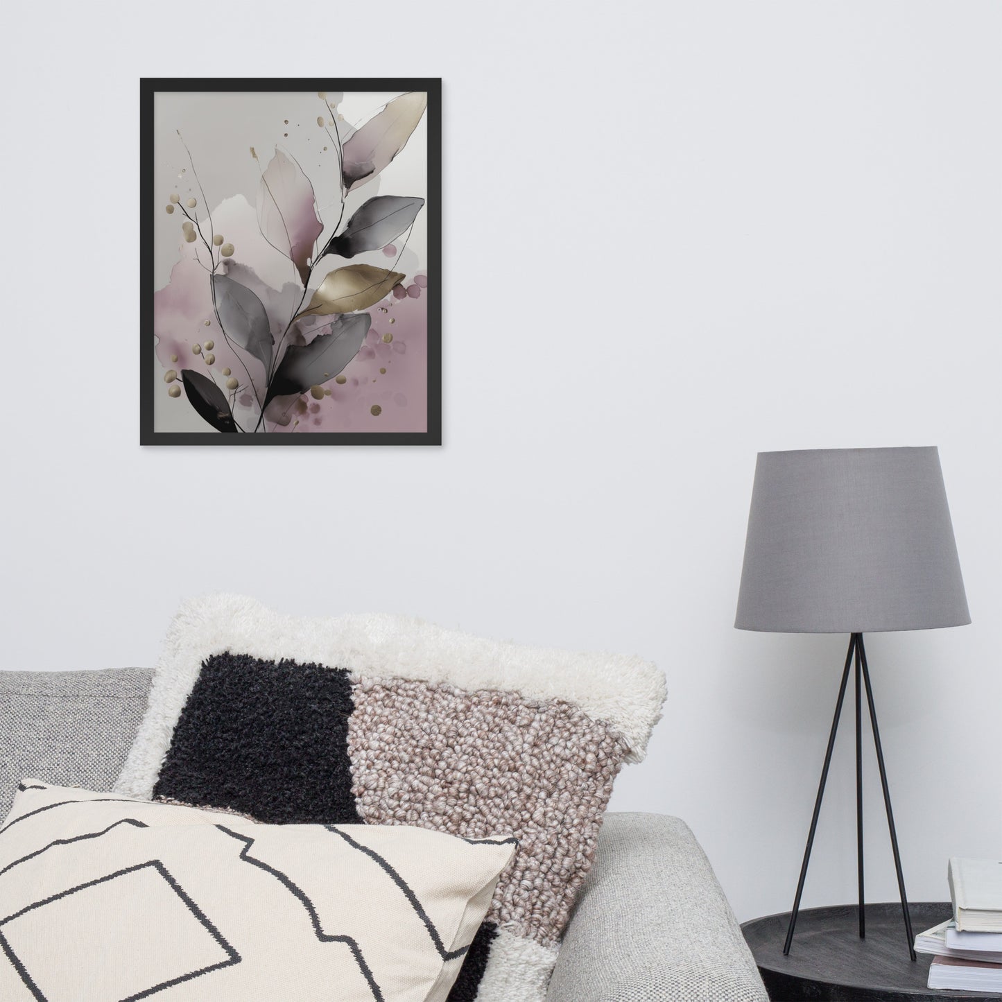 Framed floral art on a wall above a sofa with decorative pillows and a lamp.