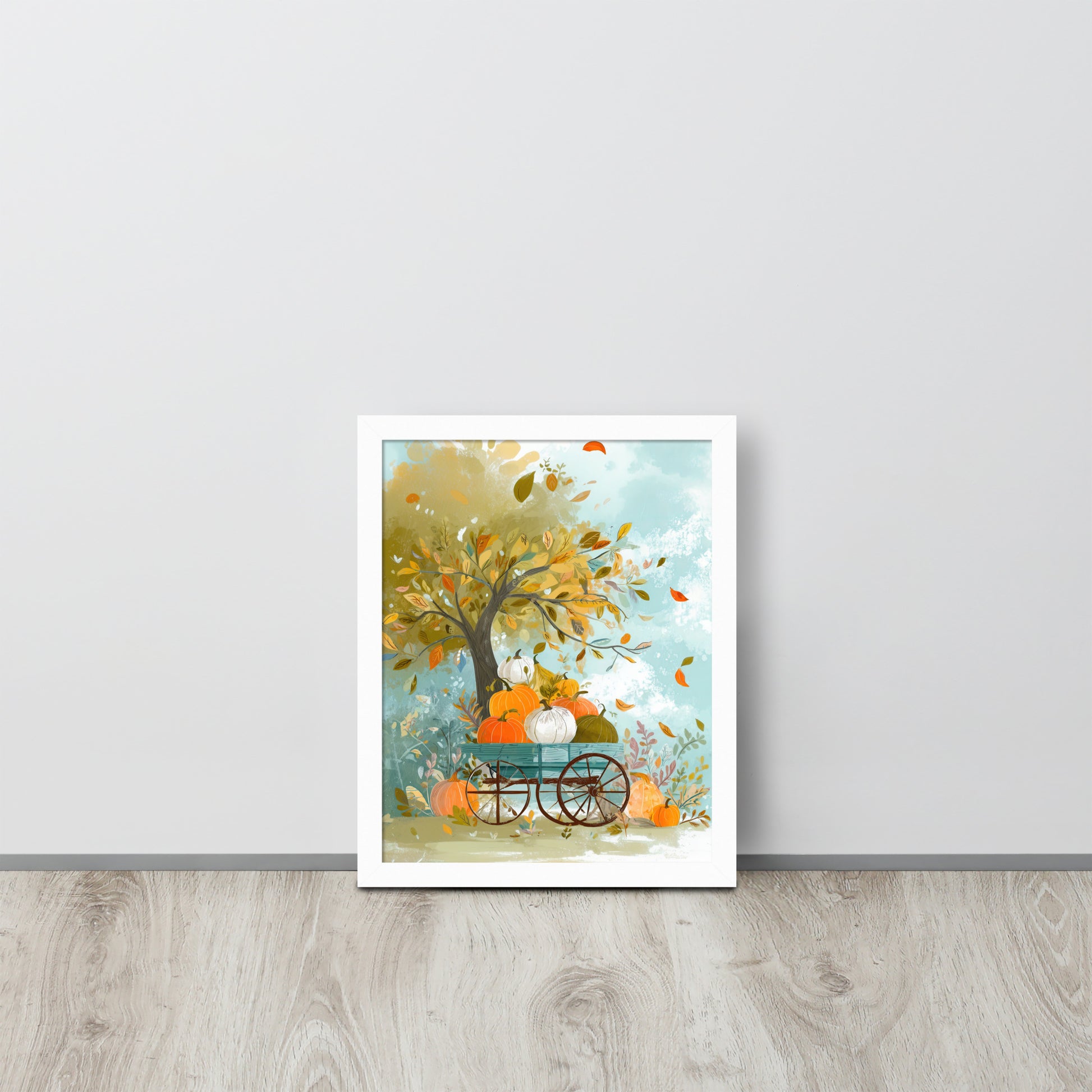 Framed poster of a tree with pumpkins and a cart on a light gray wall by Sweet and Savage. 