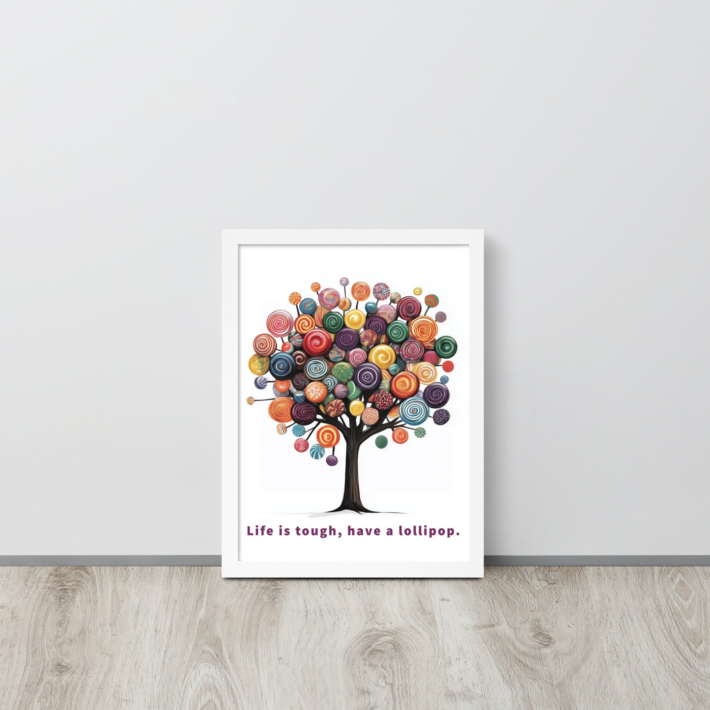Framed whimsical poster featuring a colorful tree made of lollipops with the uplifting quote 'Life is tough, have a lollipop'.