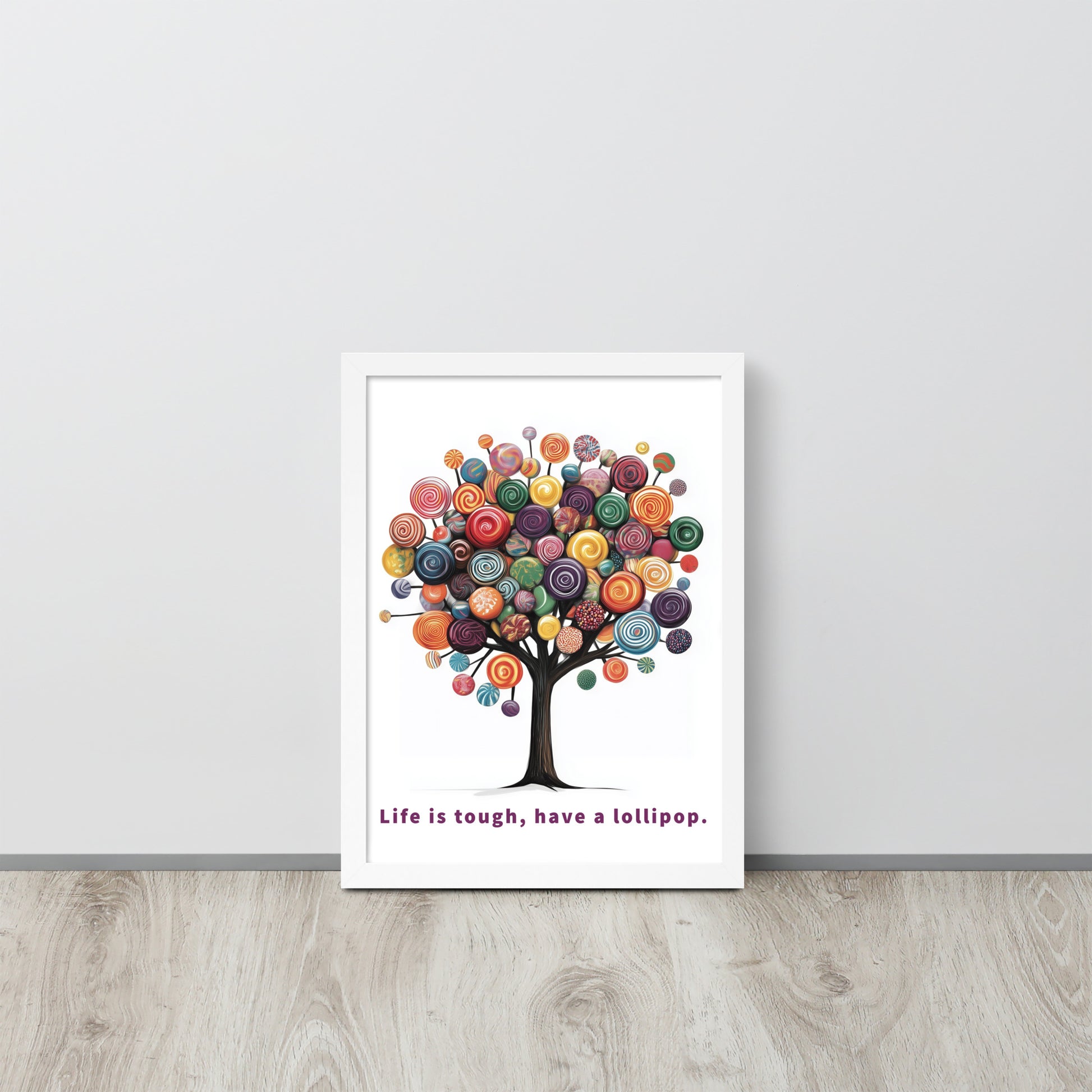 Framed whimsical poster featuring a colorful tree made of lollipops with the uplifting quote 'Life is tough, have a lollipop'.