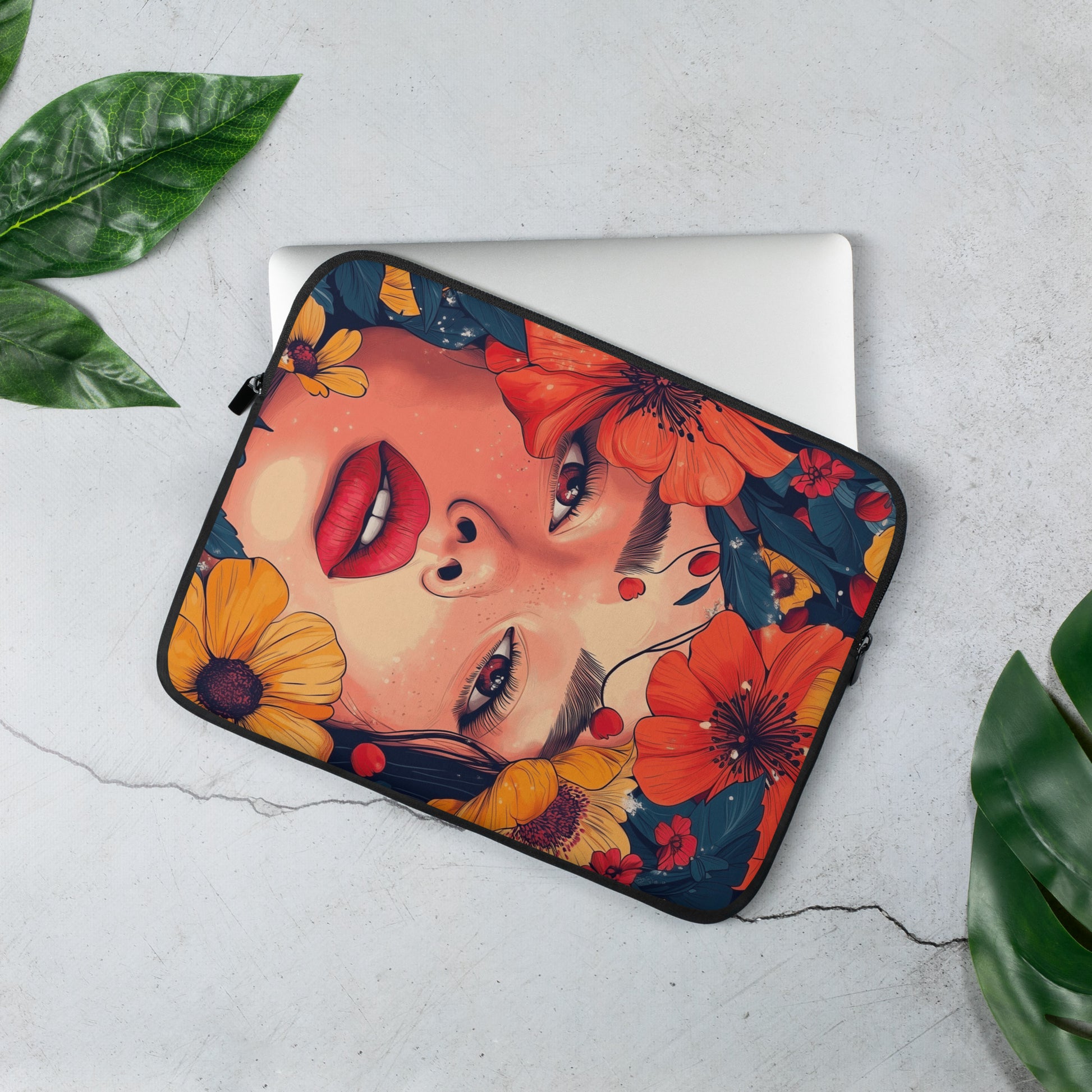 Laptop sleeve with floral and face design on a light gray background by Sweet and Savage.