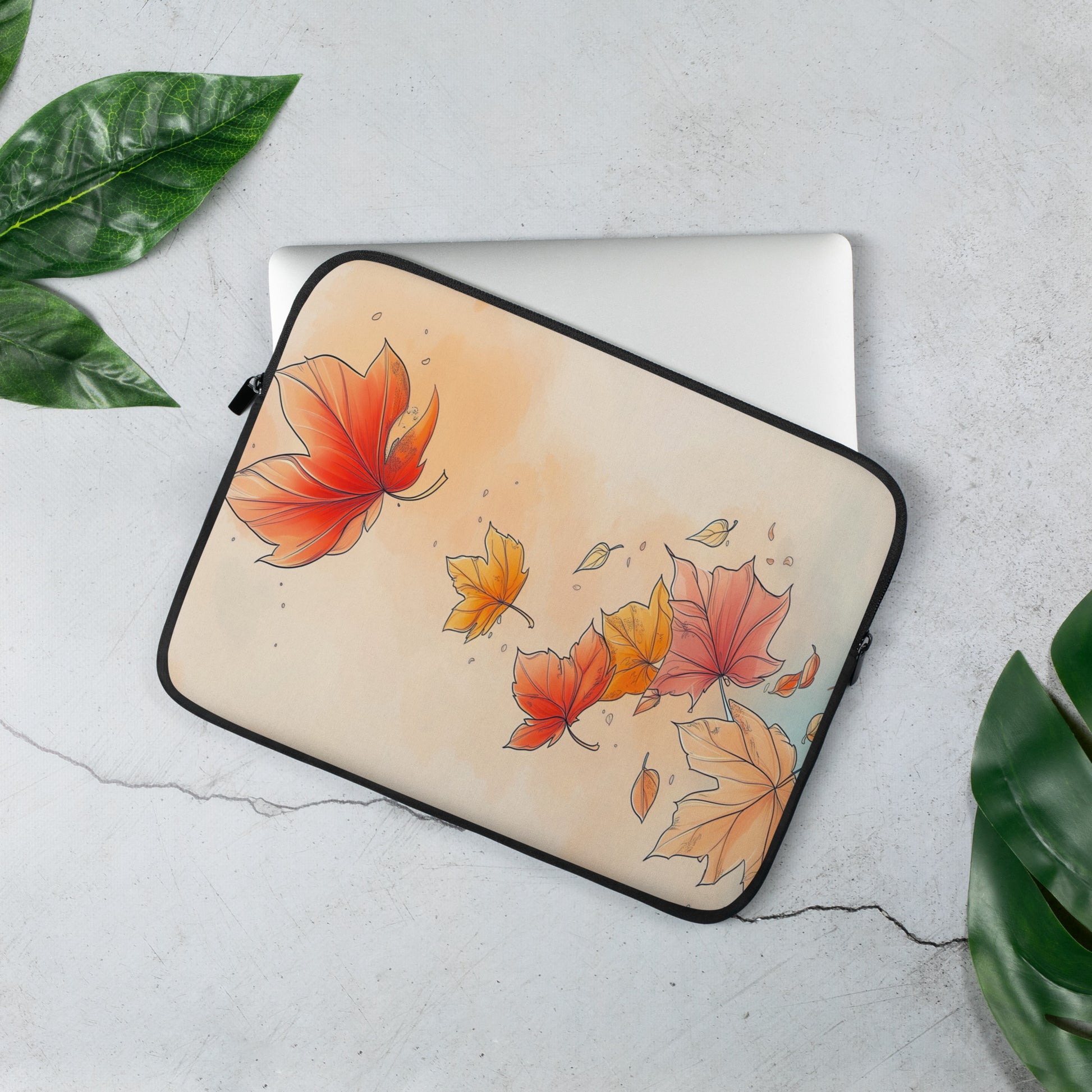A laptop sleeve featuring an autumn watercolor design with red, orange, and yellow maple leaves by Sweet & Savage on a light beige background, finished with a black zipper border.