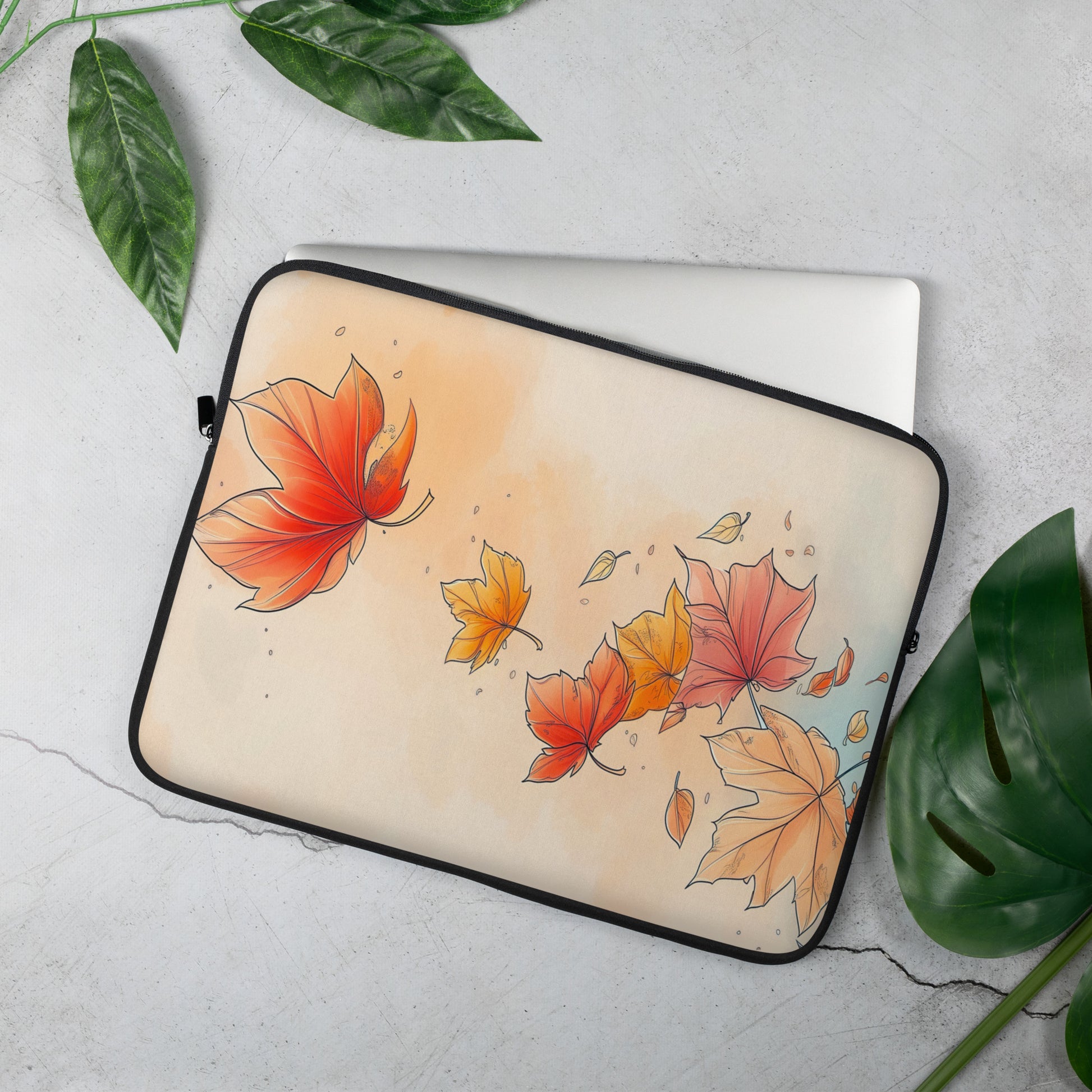 A laptop sleeve featuring an autumn watercolor design with red, orange, and yellow maple leaves by Sweet & Savage on a light beige background, finished with a black zipper border.