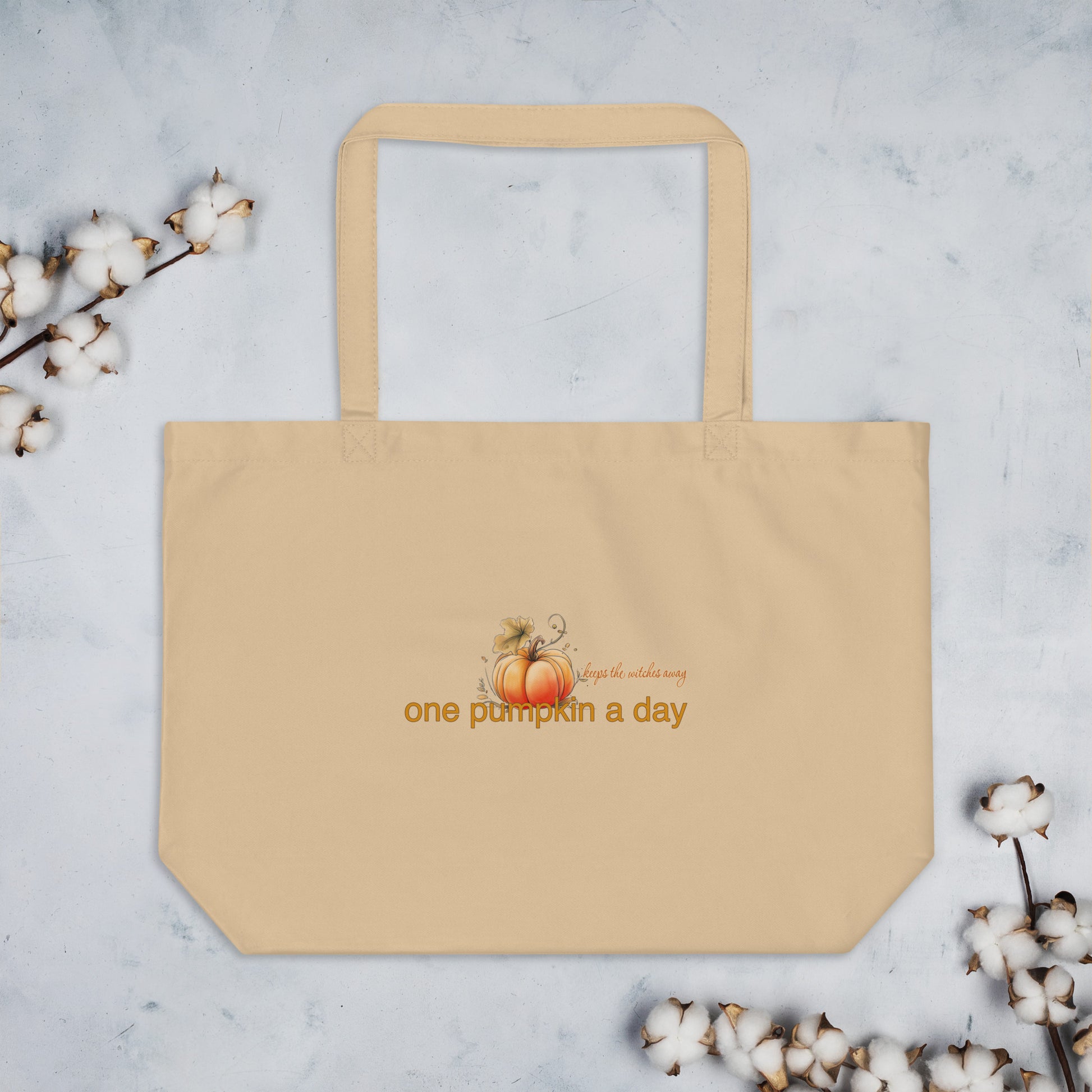 Sweet & Savage Eco Tote Bag, our cream-colored organic cotton tote features a 'one pumpkin a day' graphic with a small pumpkin illustration, showcasing its large shopper capacity.