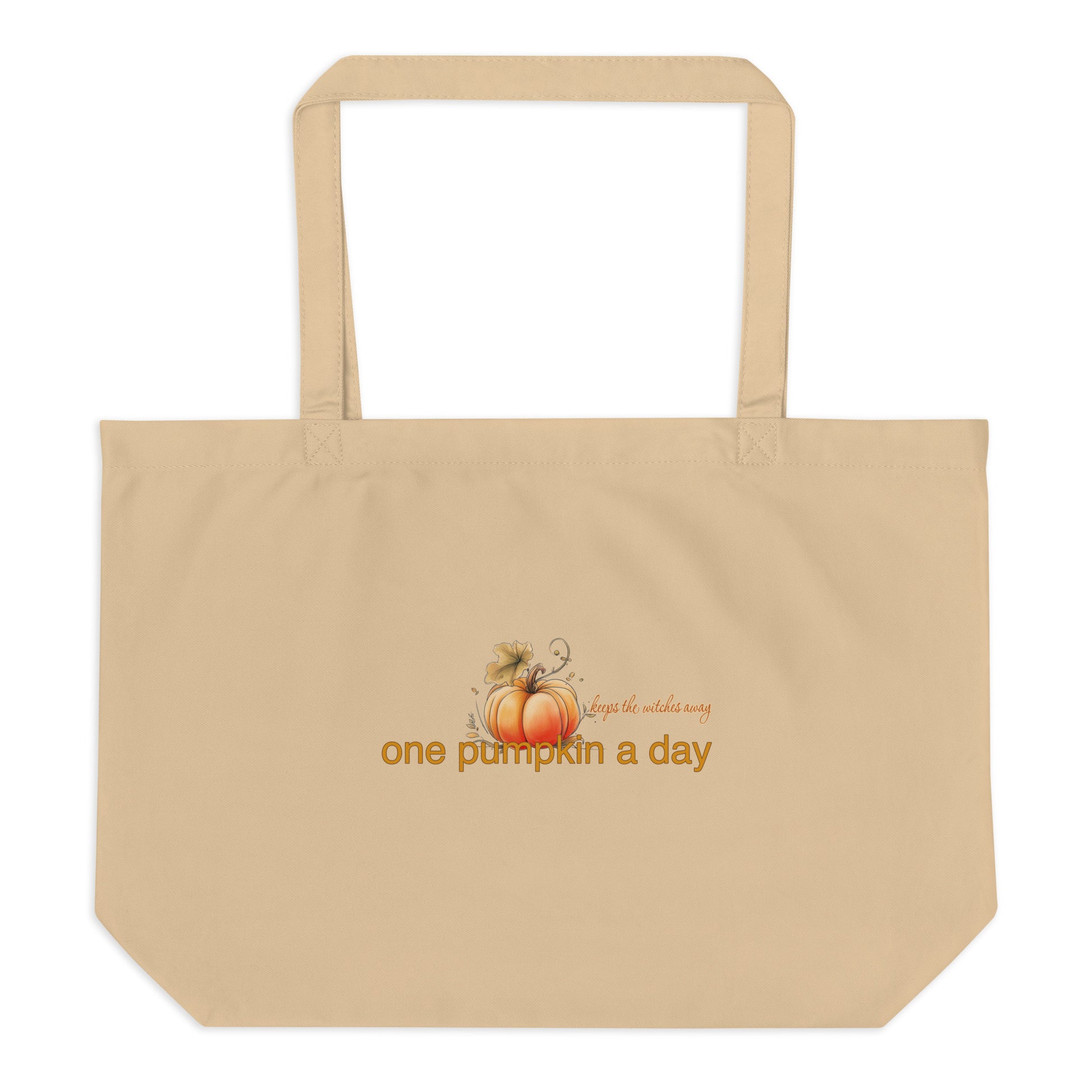 A beige canvas tote bag with two shoulder straps, featuring a small autumn graphic of pumpkins and the text 'One pumpkin a day, keeps the witches away' printed on the front, shown against a plain white background.