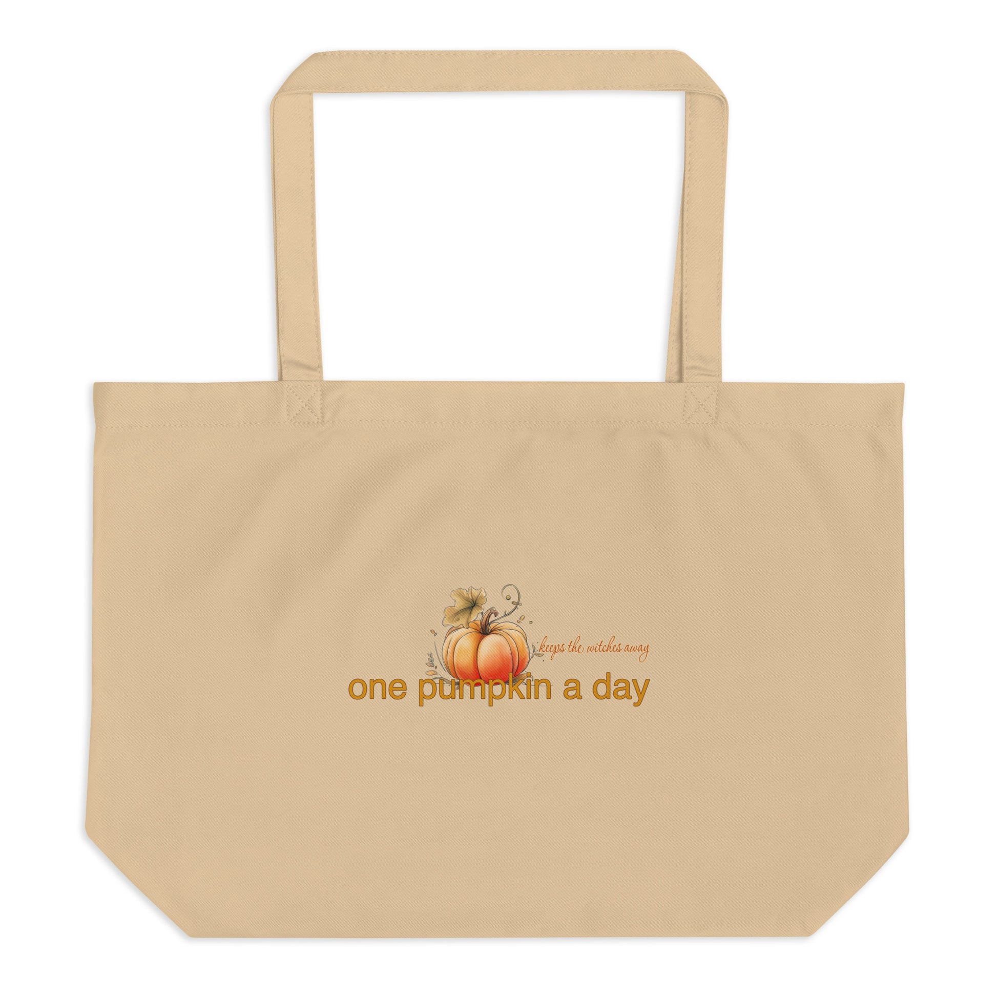 A beige canvas tote bag with two shoulder straps, featuring a small autumn graphic of pumpkins and the text 'One pumpkin a day, keeps the witches away' printed on the front, shown against a plain white background.