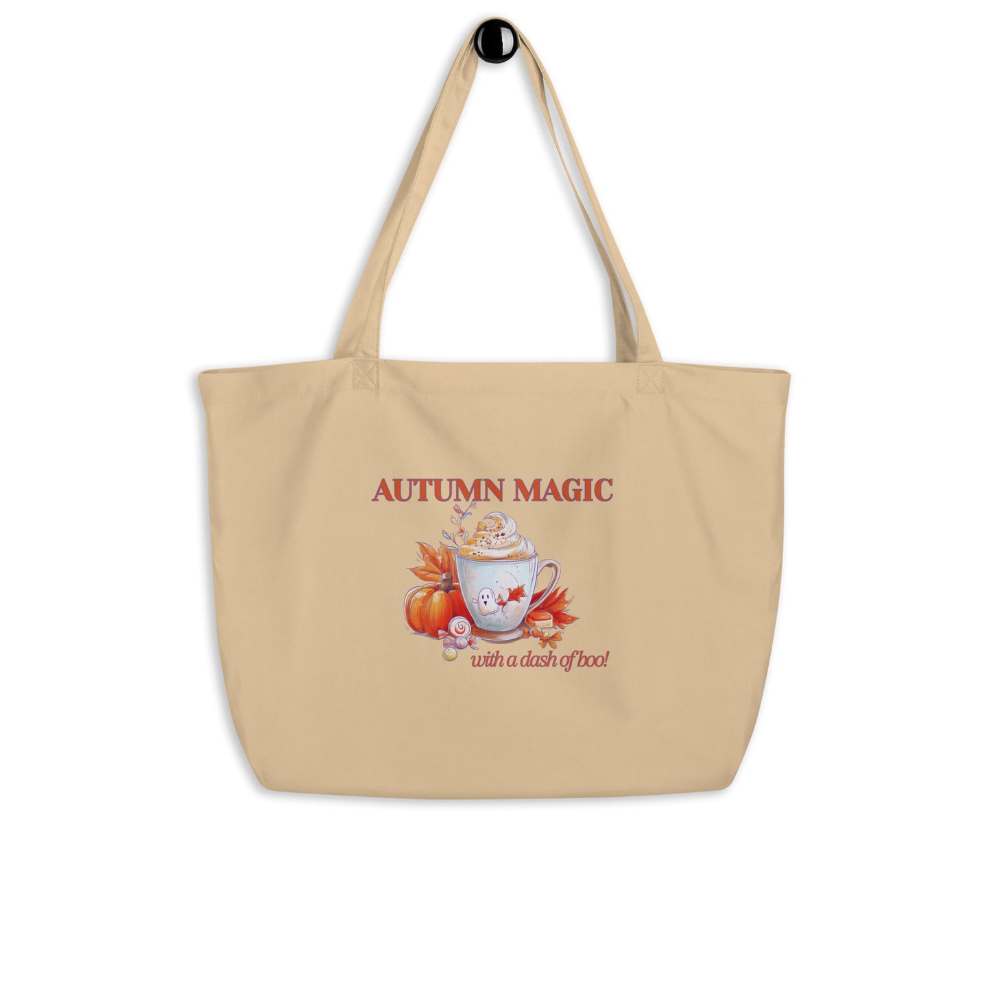 A beige canvas tote bag with a black top hook, featuring an autumn-themed graphic with the text 'AUTUMN MAGIC with a dash of boo' and an illustration of a mug, pumpkin, and fall leaves.
