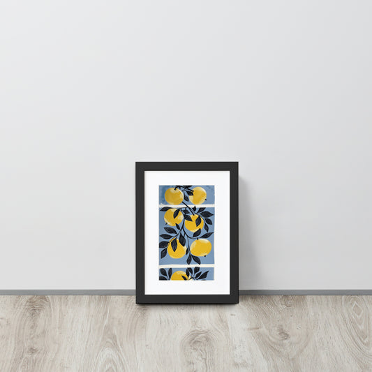 Framed poster with yellow apple design on a white wall.