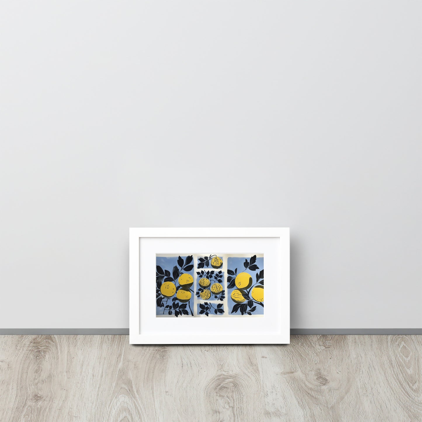 Framed abstract artwork with yellow watermelon design and yellow elements on a light gray wall.
