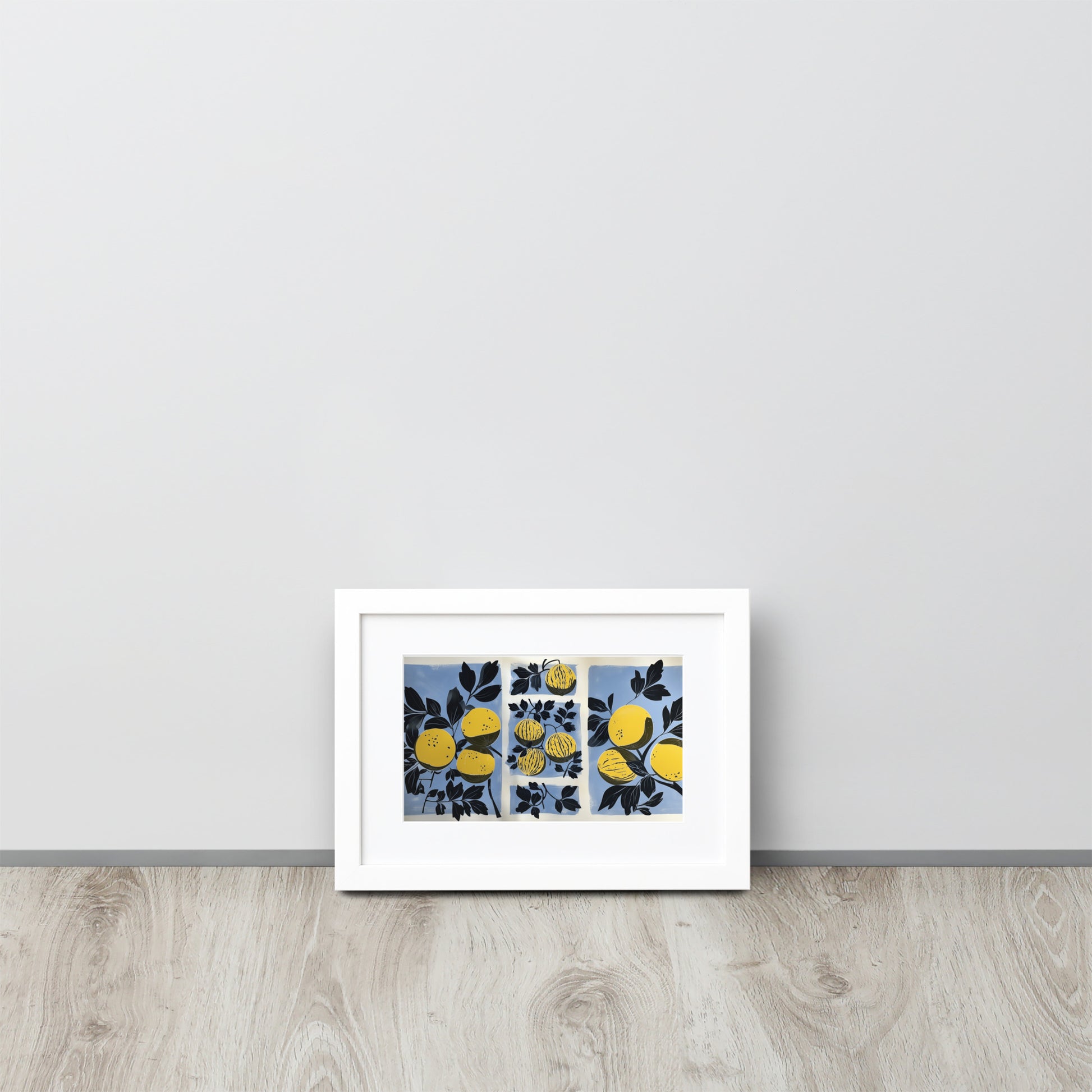 Framed abstract artwork with yellow watermelon design and yellow elements on a light gray wall.