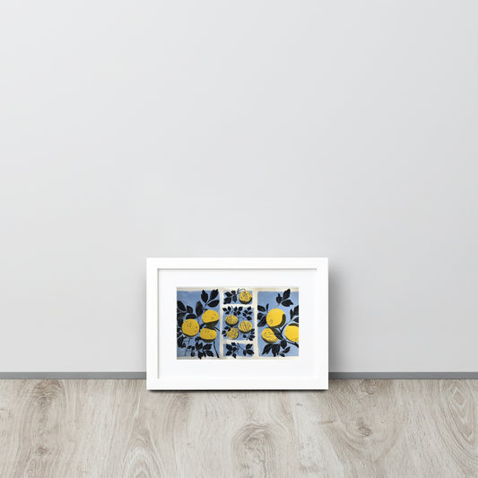 Framed abstract artwork with yellow watermelon design and yellow elements on a light gray wall.