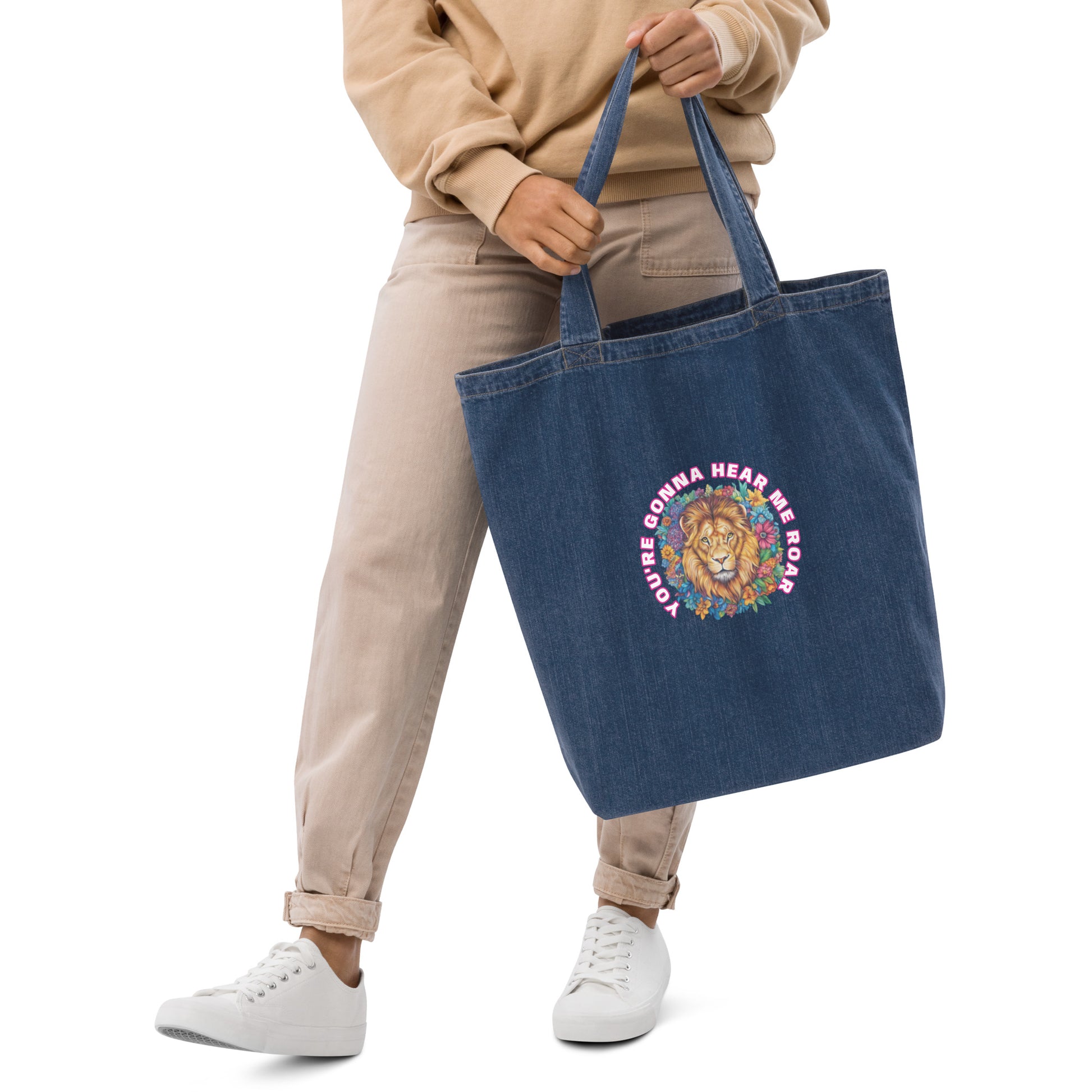 Woman carrying a navy blue organic denim tote bag featuring a colorful artistic lion design.