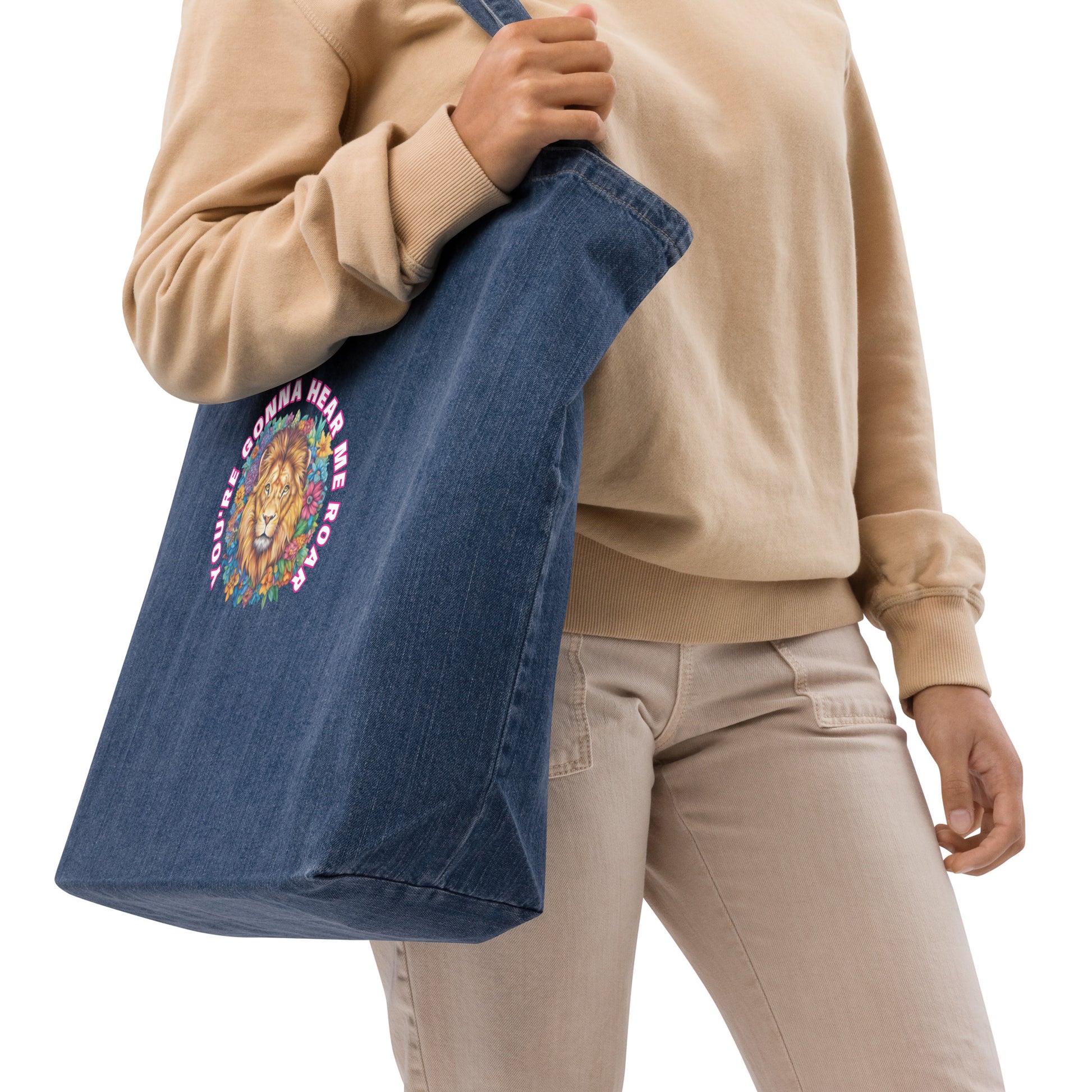 Woman carrying a navy blue organic denim tote bag featuring a colorful artistic lion design.