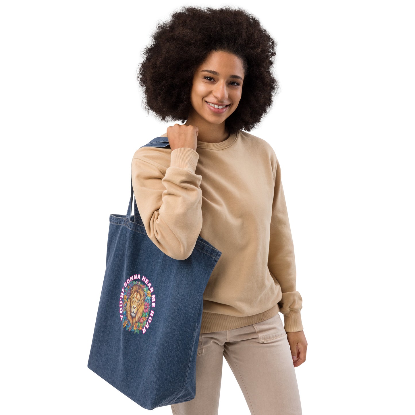 Woman carrying a navy blue organic denim tote bag featuring a colorful artistic lion design.