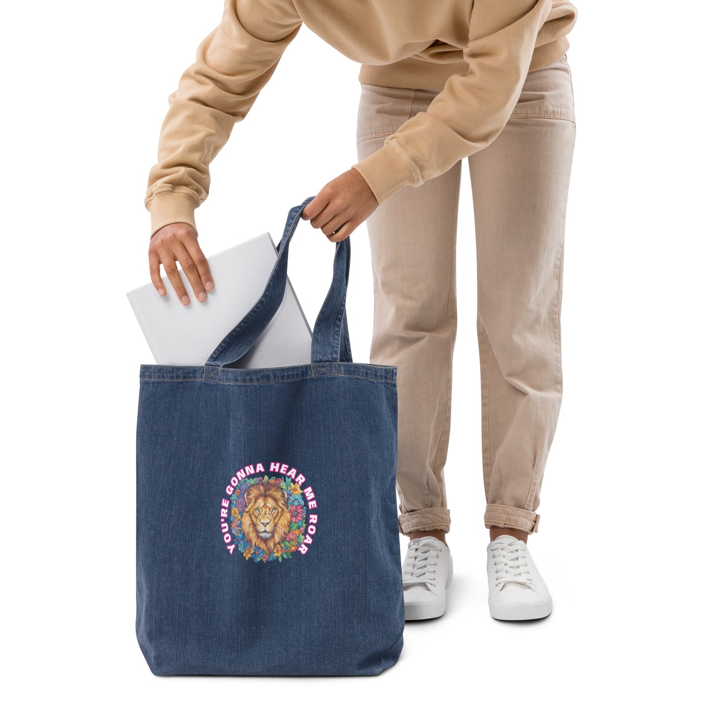 Woman carrying a navy blue organic denim tote bag featuring a colorful artistic lion design.