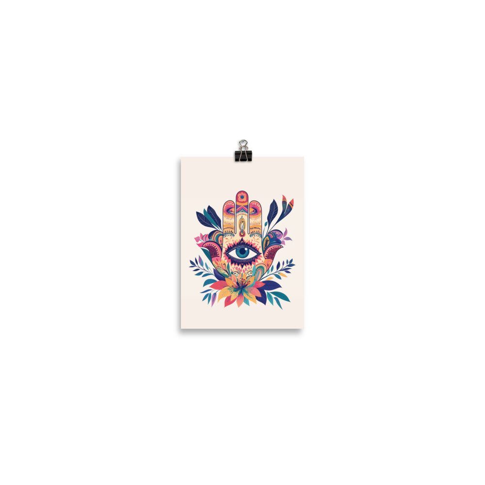 A colorful Hamsa hand illustration featuring an eye in the palm, surrounded by intricate floral patterns and vibrant blue and pink accents. Small museum-quality art poster by Sweet & Savage.