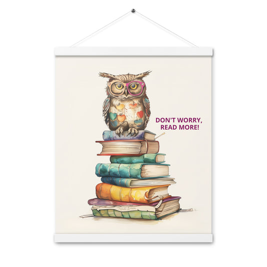 Whimsical illustration of an owl sitting on a tall stack of colorful books with the text "Don't Worry, Read More!". The poster is displayed with natural light-wood magnetic hangers and a hanging string.