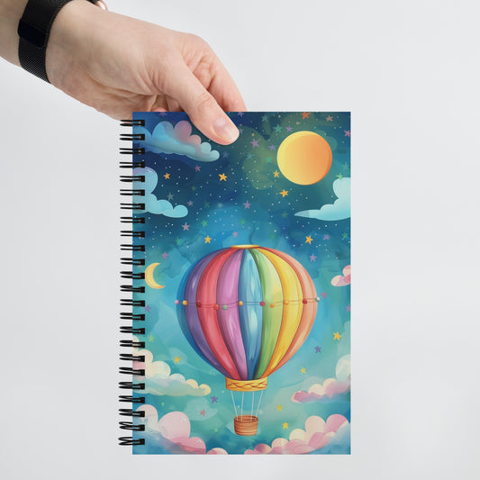 Spiral notebook featuring an enchanting air balloon and galaxy art design on a soft background by Sweet & Savage.