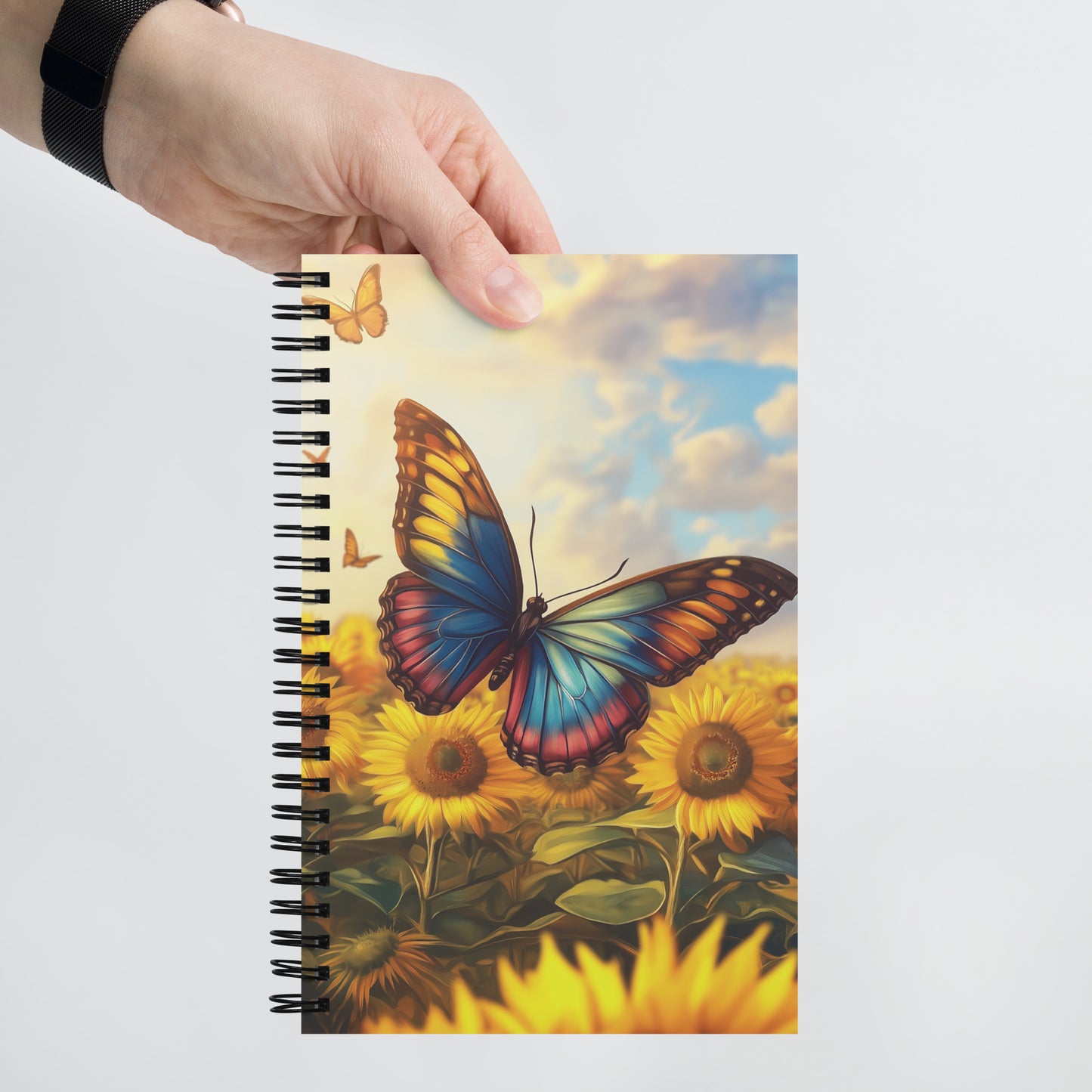Spiral notebook featuring a vibrant, artistic butterfly design with expressive colors and bold details by Sweet & Savage.
