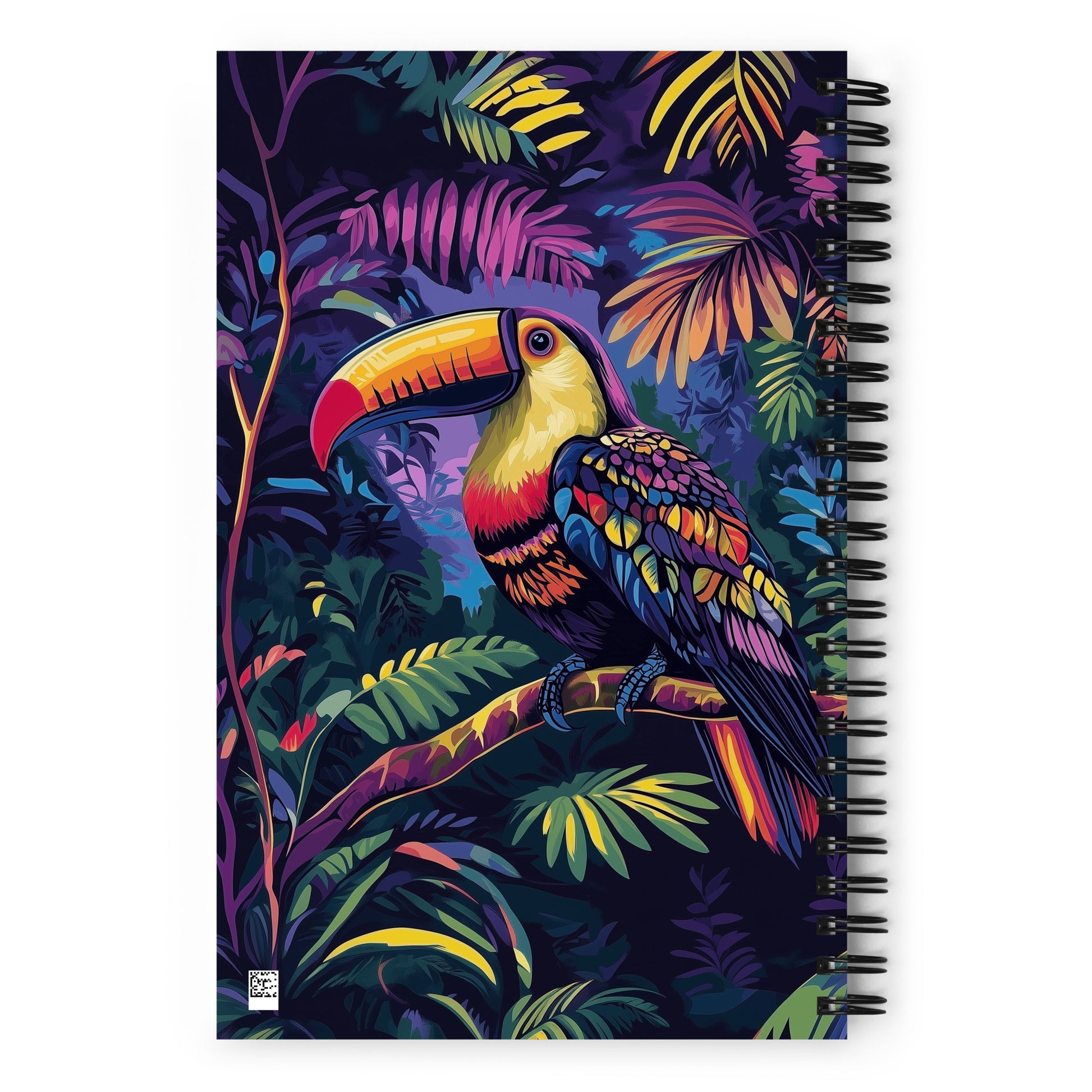 Spiral notebook with a colorful toucan and tropical leaves design on a white background. 