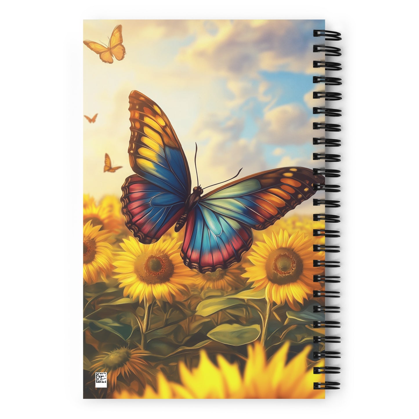 Spiral notebook with a colorful butterfly and sunflower design by Sweet and Savage on the cover. 